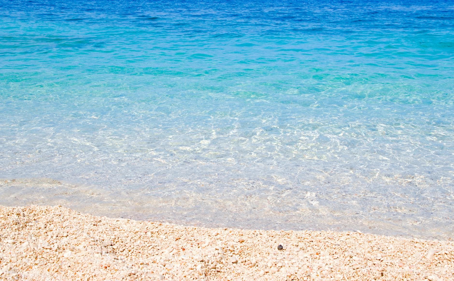 Crystal clear waters and sandy beach in Sardinia, perfect for summer relaxation.