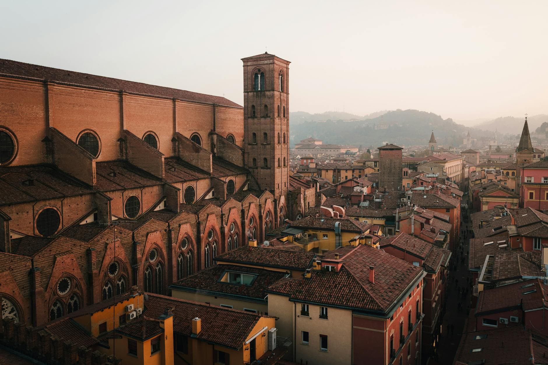 A breathtaking aerial view of Bologna's historic architecture at dusk, highlighting its rustic charm.
