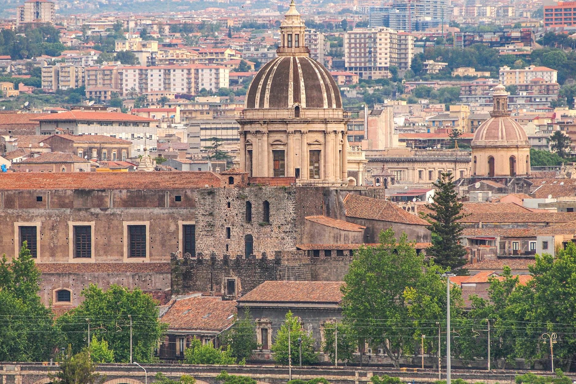 Panoramic view of Catania's historic architecture featuring domes and cityscape.