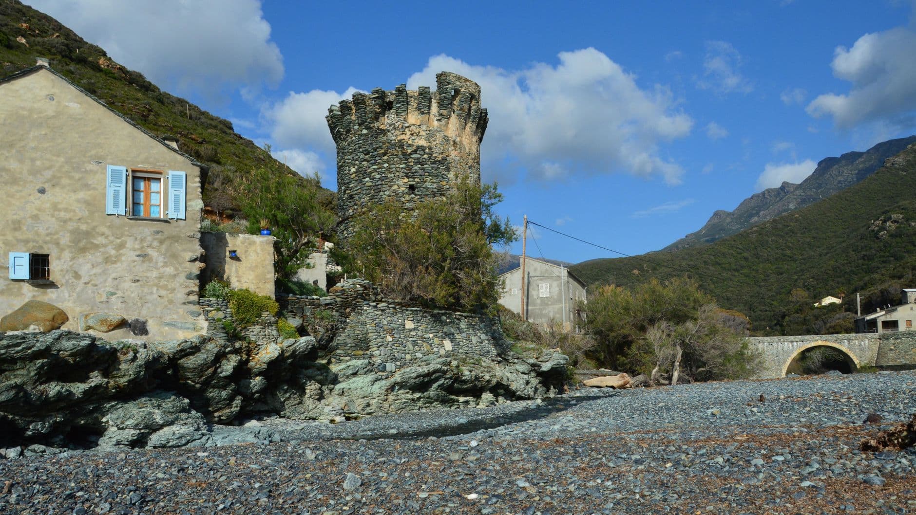 Scenic view of a historic tower and coastal landscape in Olmeta-di-Capocorso, Corsica, France.