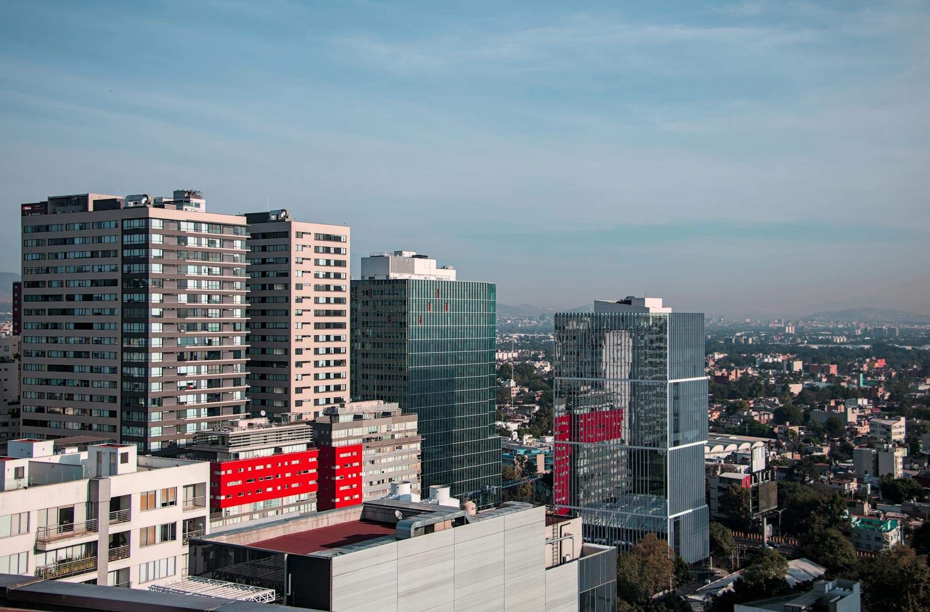 Aerial view of modern skyscrapers in Ciudad de México's downtown area on a clear day.