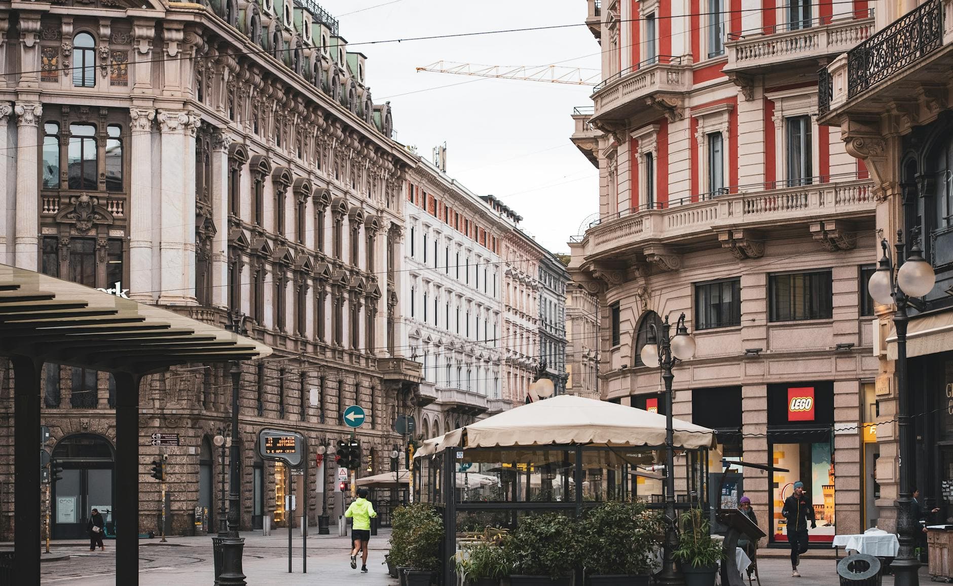 Charming street scene capturing the ornate architectural facades in Milan, Italy.