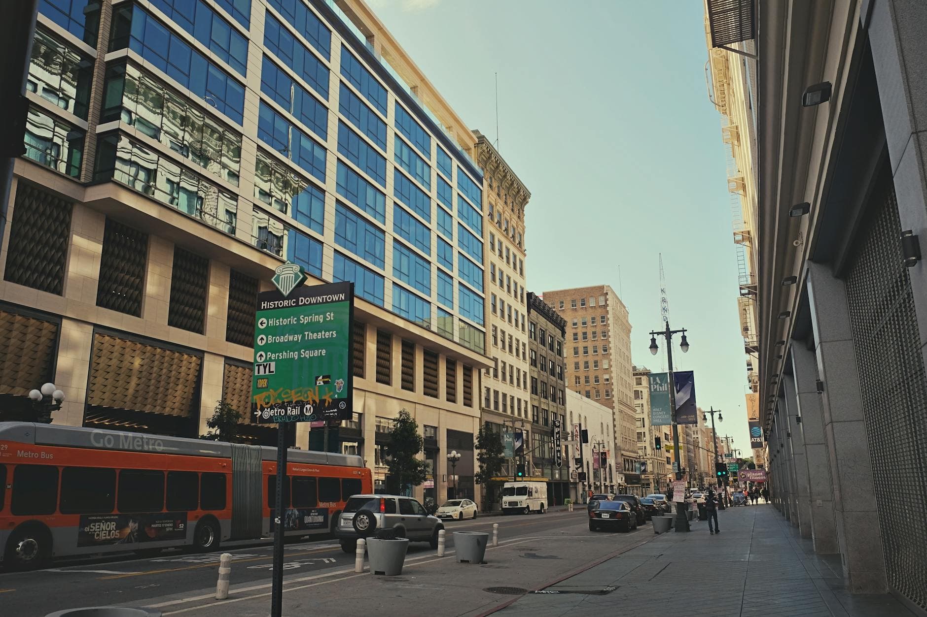Vibrant street view of historic downtown Los Angeles featuring tall buildings and busy traffic.