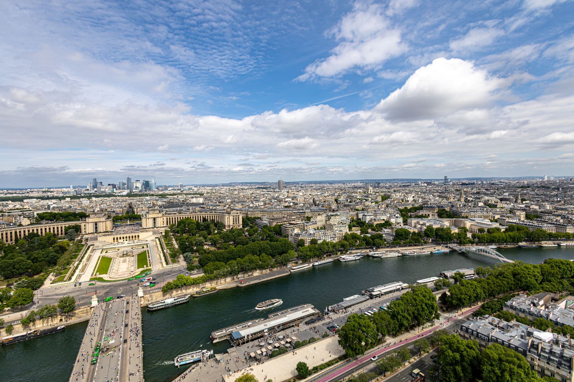 Stunning aerial view of Paris showcasing the Seine River and Trocadéro Gardens with clear skies.