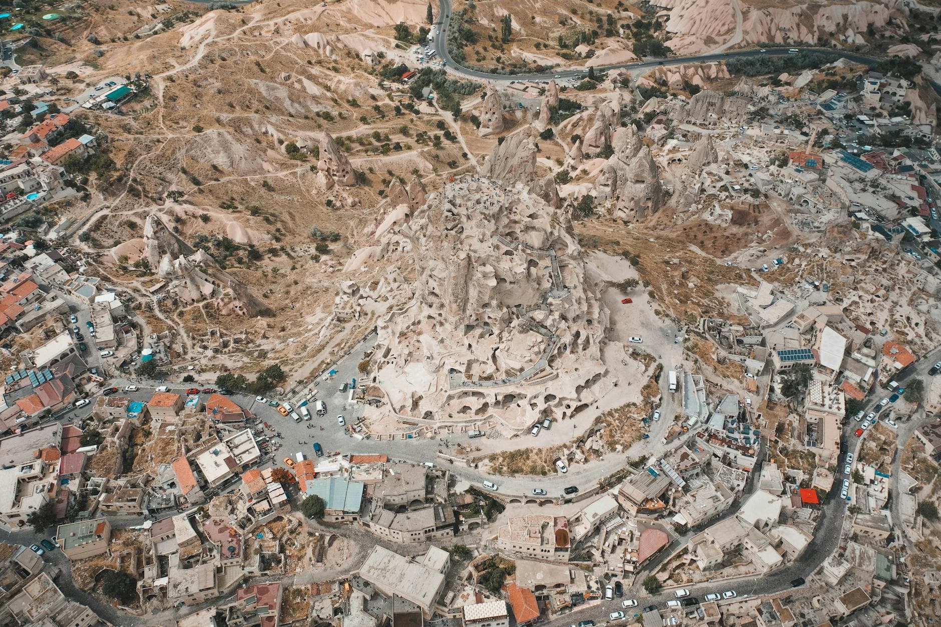 Stunning aerial view of Uçhisar Castle and surrounding landscape in Cappadocia, Turkey.