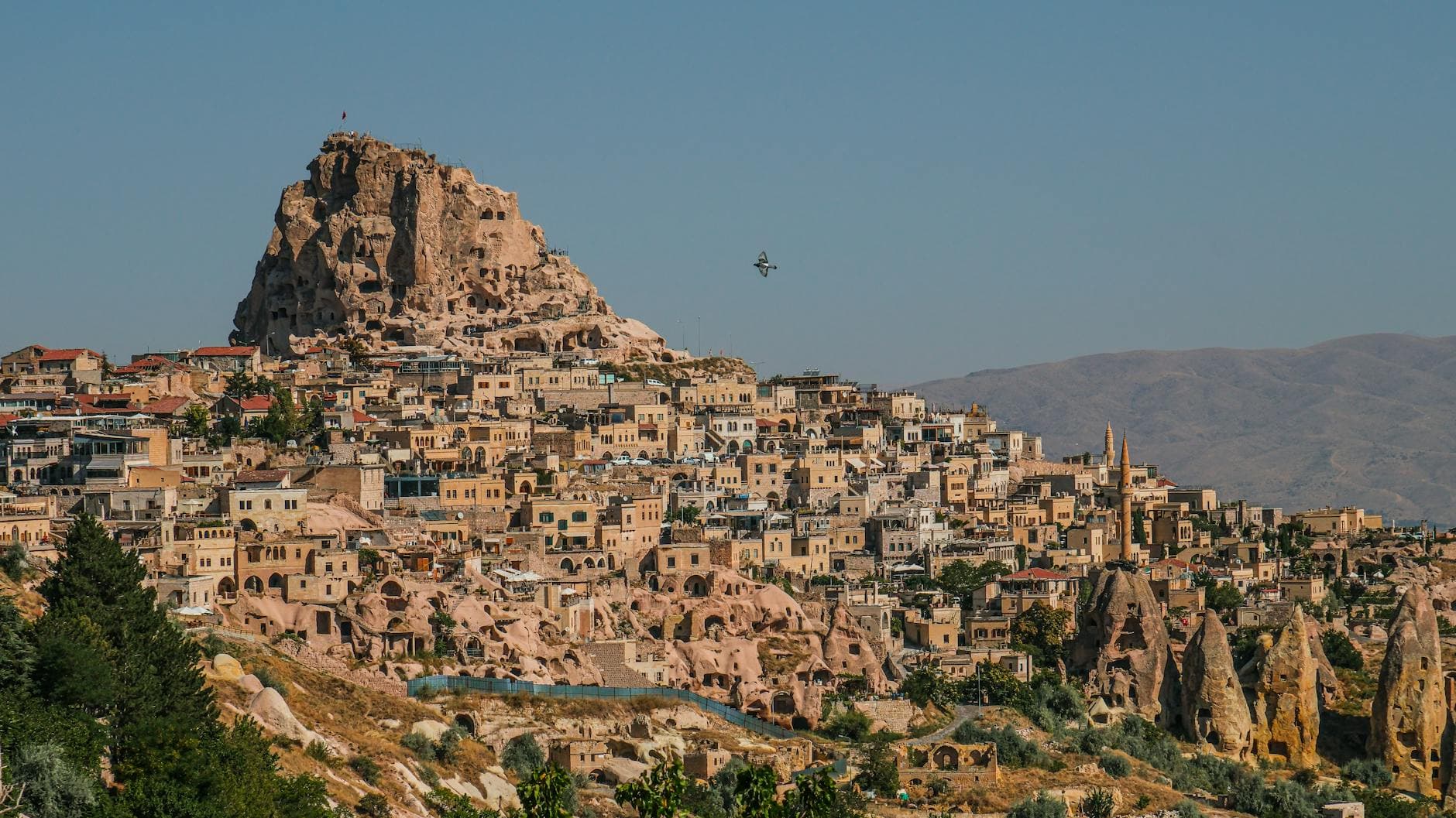 Stunning view of Uçhisar Castle in Cappadocia, Turkey, showcasing unique rocky formations and traditional town.