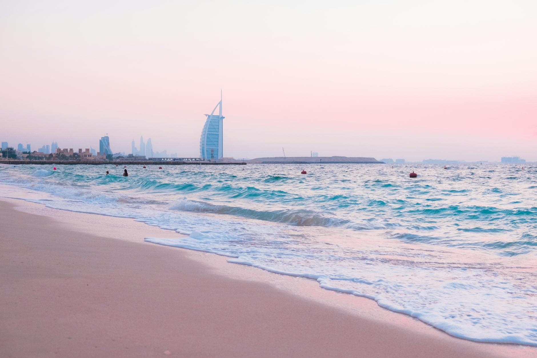Stunning sunset view of Jumeirah Beach showcasing the iconic Burj Al Arab and tranquil sea waters.