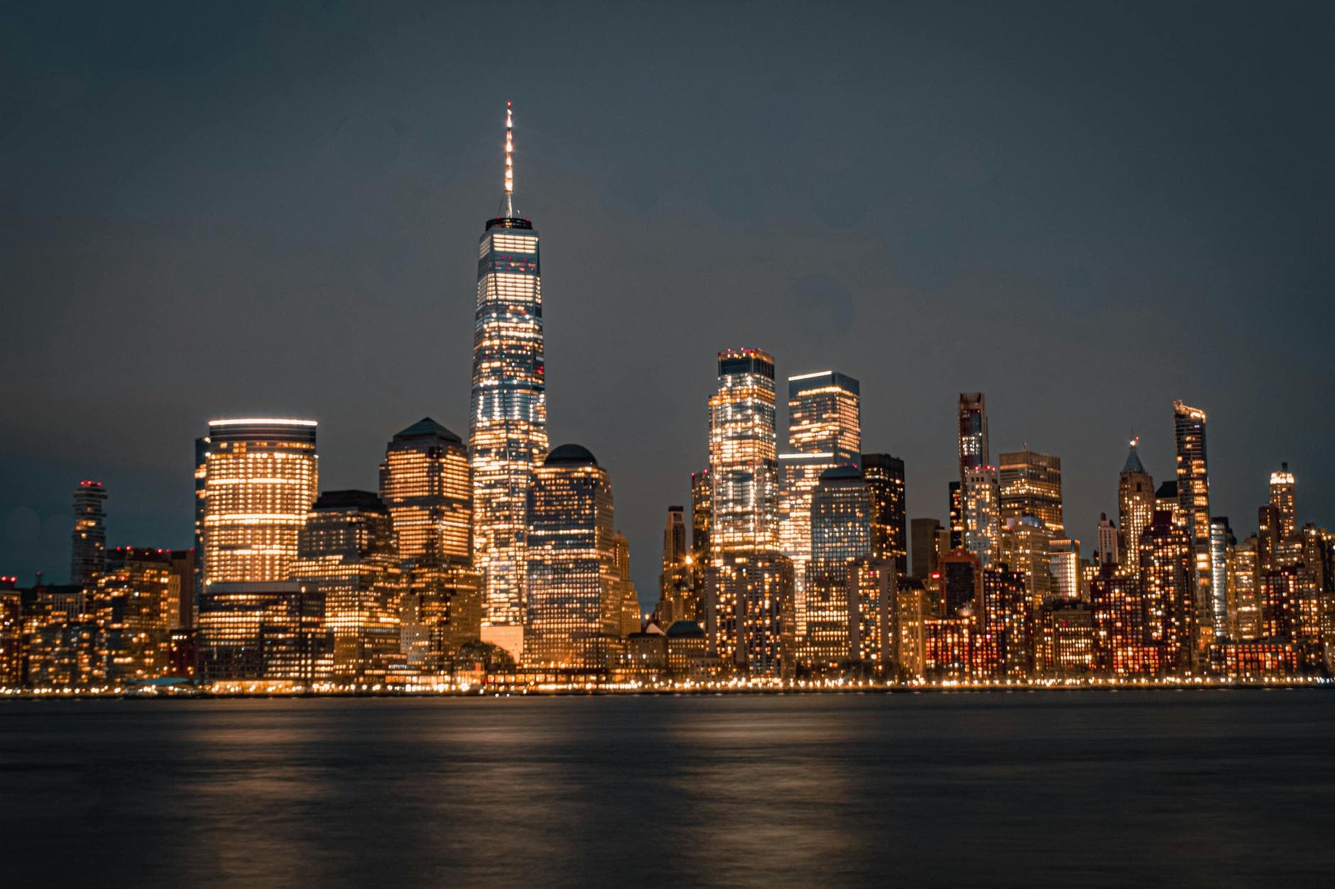 Stunning view of the New York City skyline illuminated at night from the waterfront.