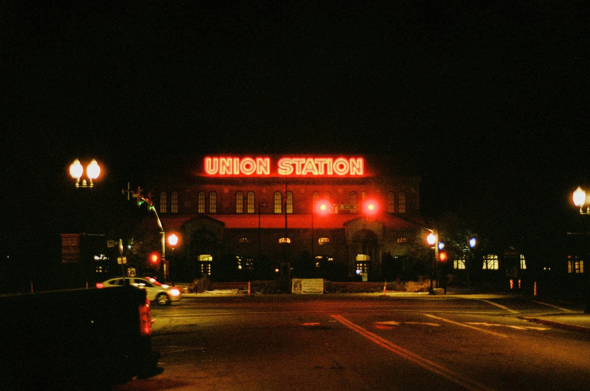 Union Station illuminated at night with striking neon lights and street view.