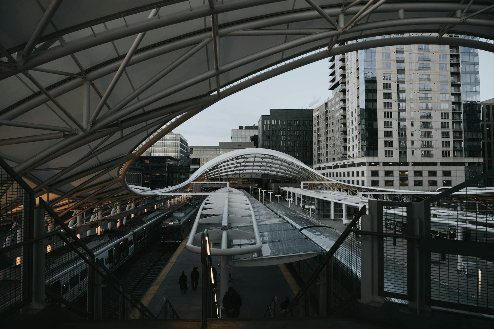 View of the sleek contemporary design at Denver Union Station with downtown buildings.