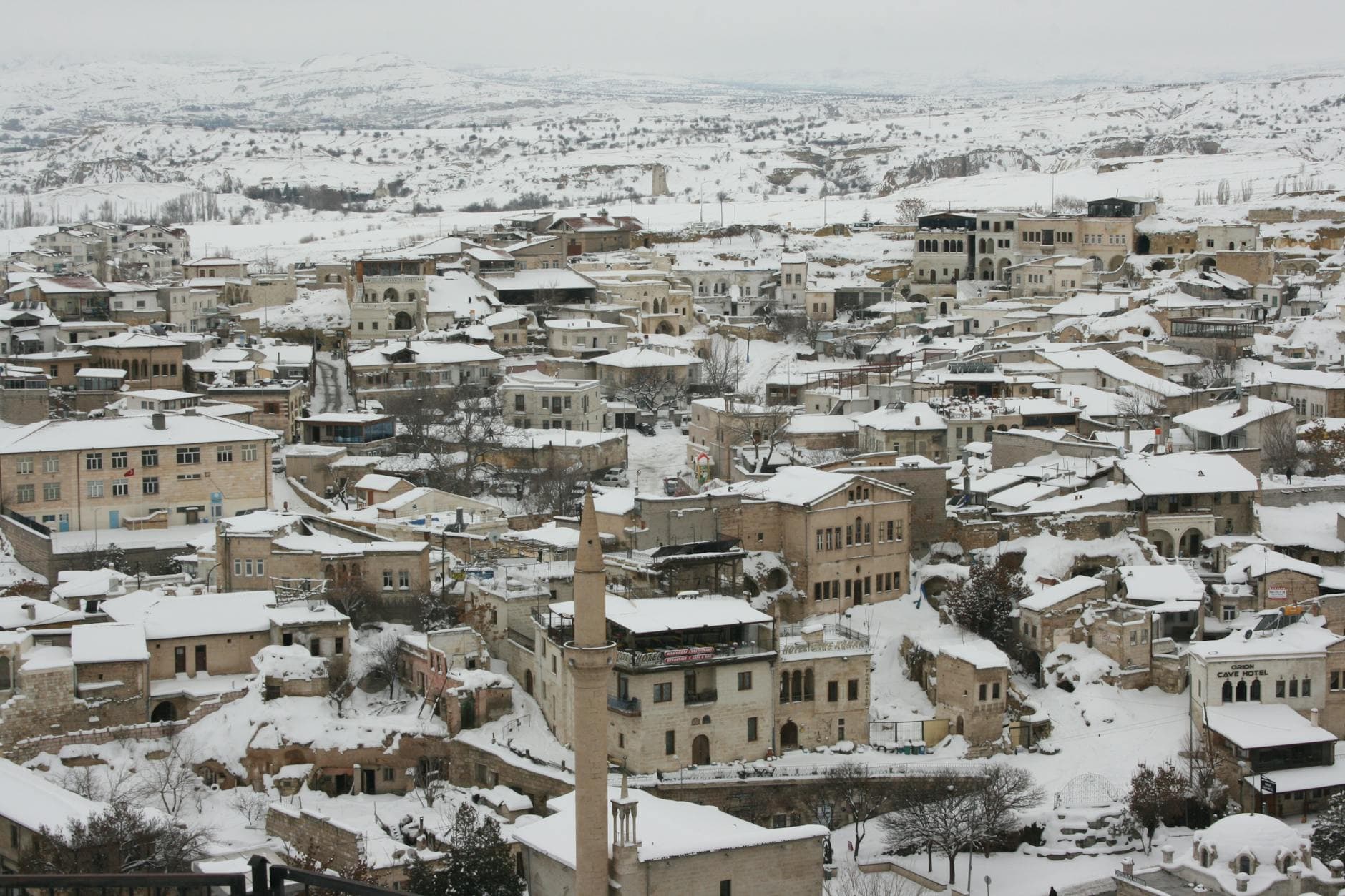 A snowy aerial view of Ürgüp, Cappadocia showcasing traditional architecture.