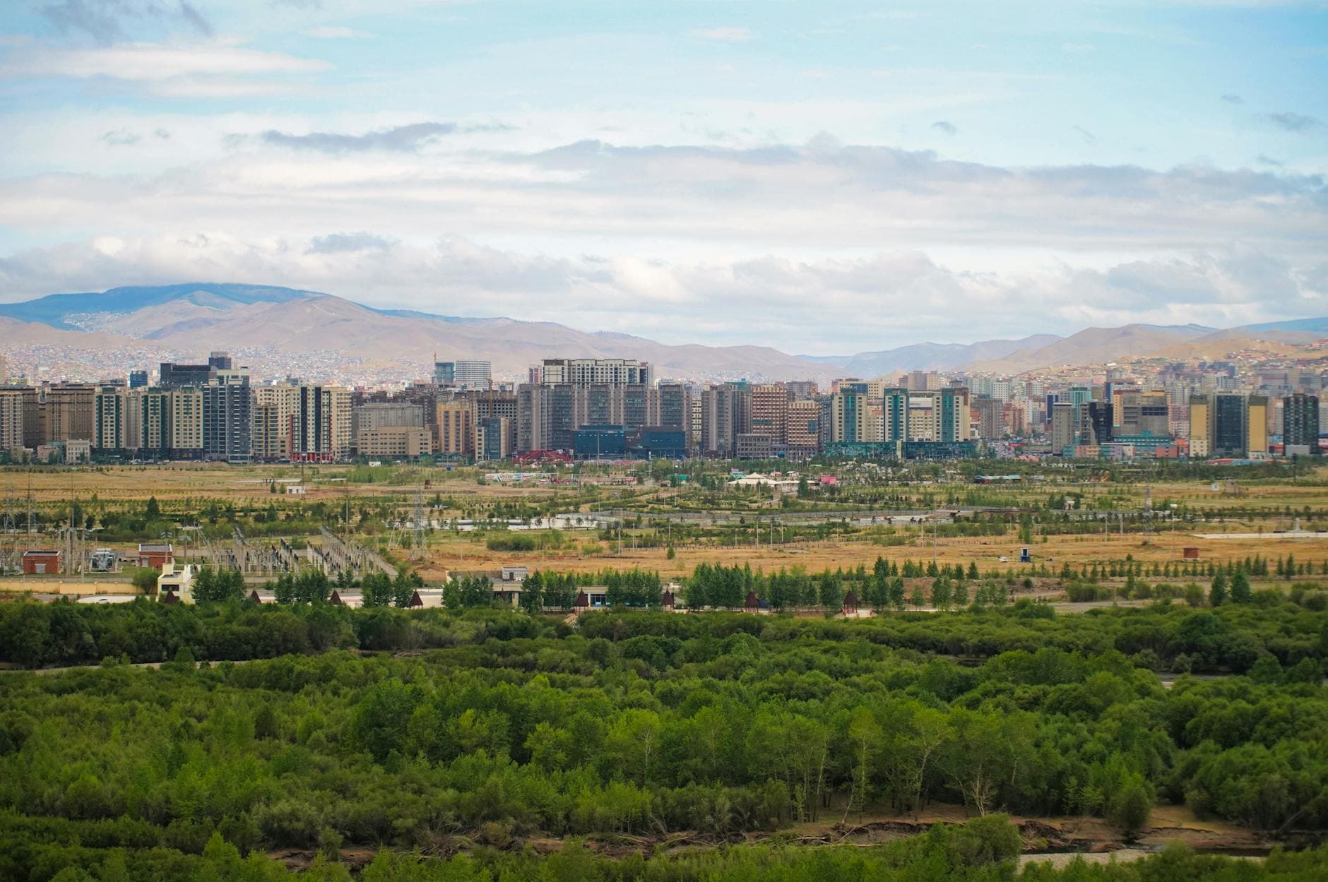 Panoramic view of Ulaanbaatar with greenery and mountains in Mongolia.