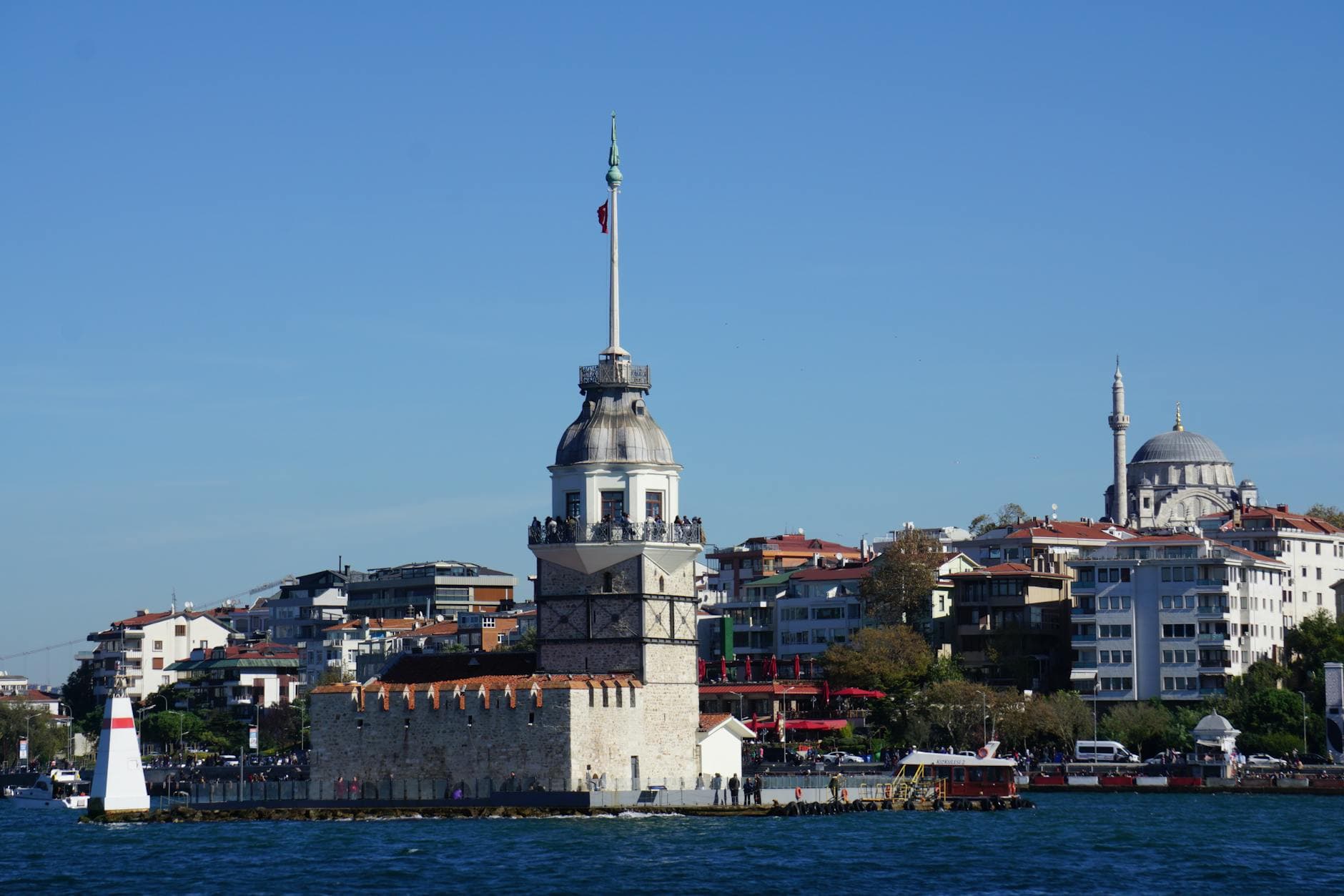 Iconic Maiden's Tower with Istanbul skyline, showcasing Üsküdar's waterfront charm.