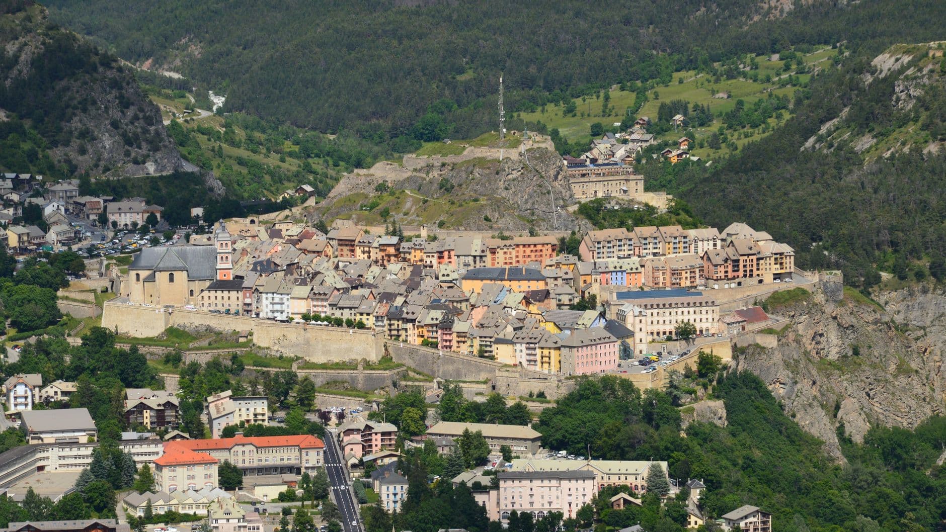 Drone shot of the historic fortified city of Briançon, nestled in the picturesque French Alps.