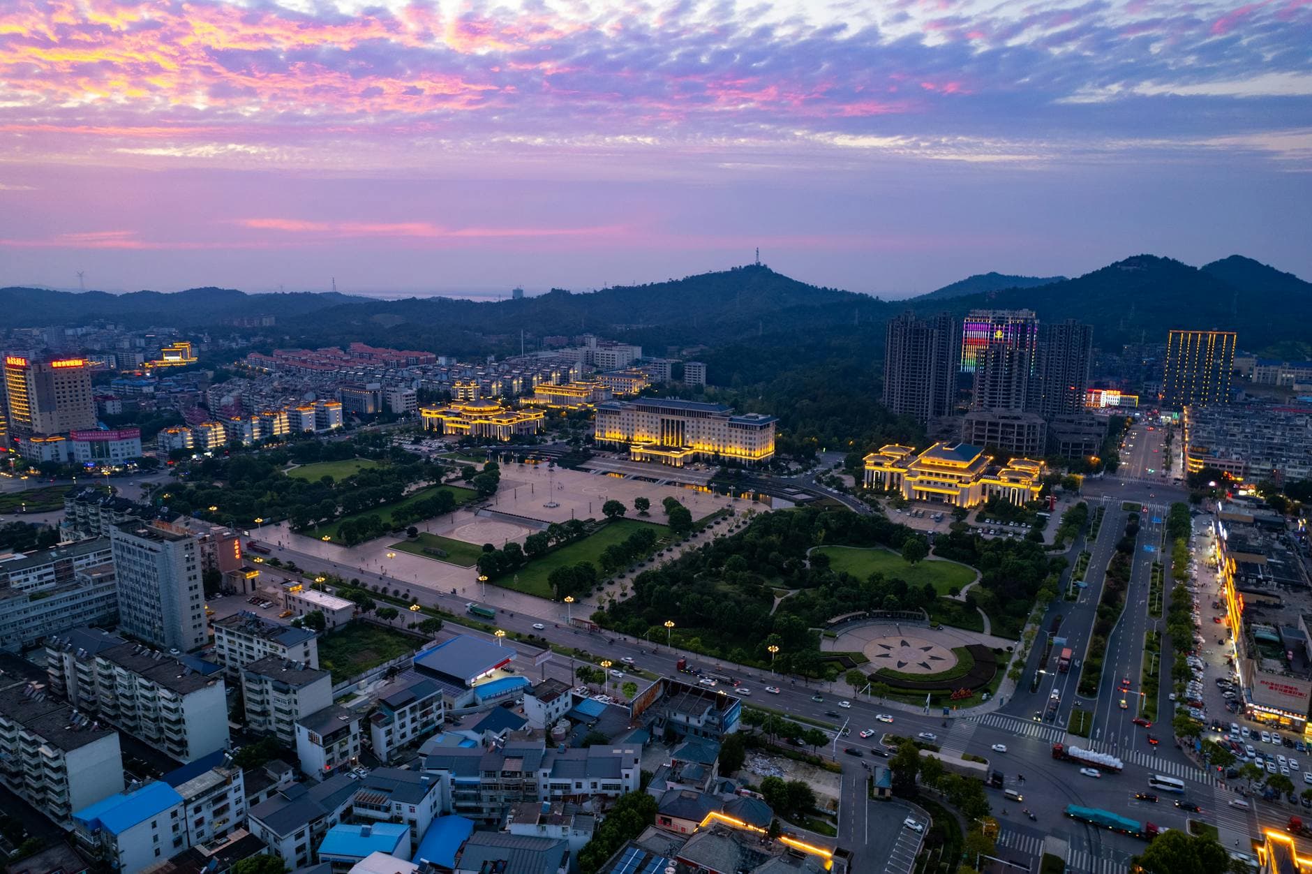 A stunning evening aerial view of Jiujiang, China with its illuminated streets and vibrant skyline.