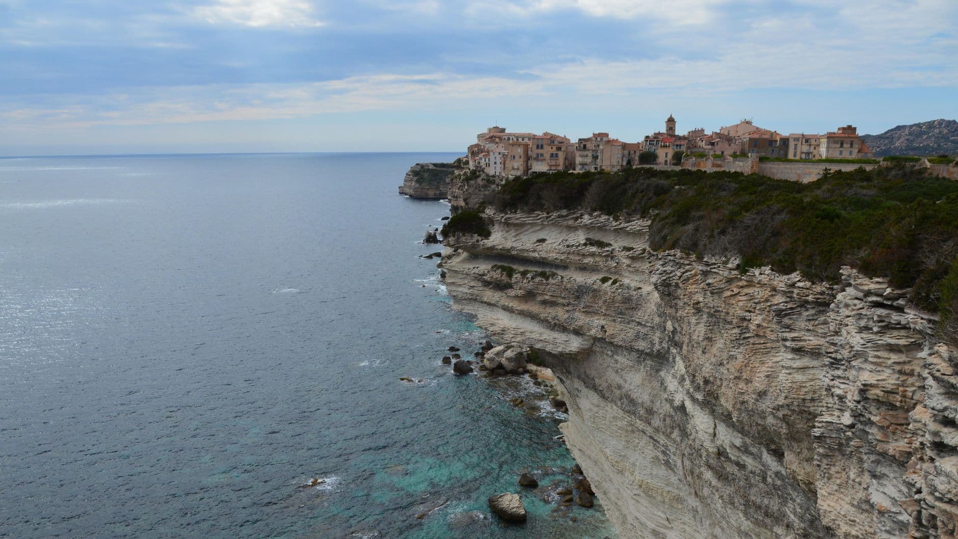 View of Bonifacio's coastal cliffs and historic town in southern Corsica.