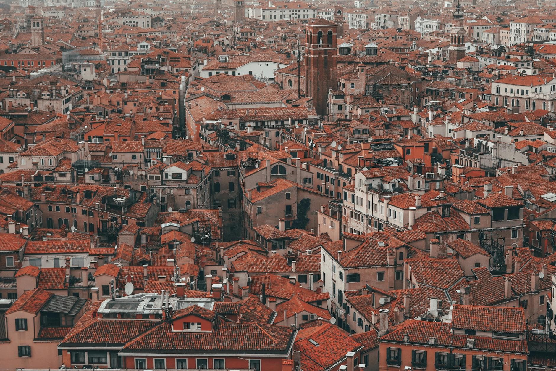 Stunning aerial view of Venice's iconic red rooftops and historic architecture.