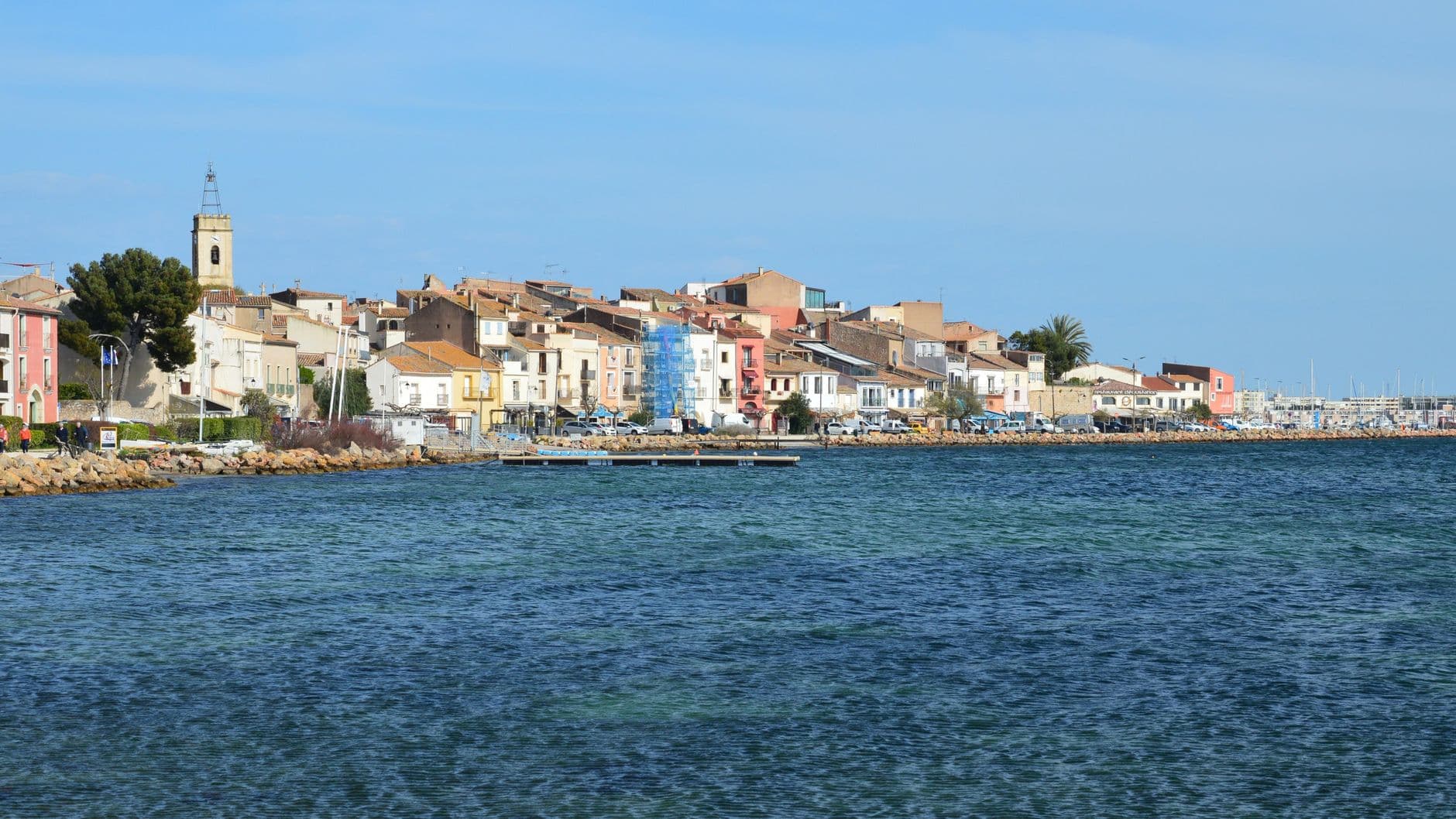 Charming waterfront view of Bouzigues village with colorful houses in Occitanie, France.