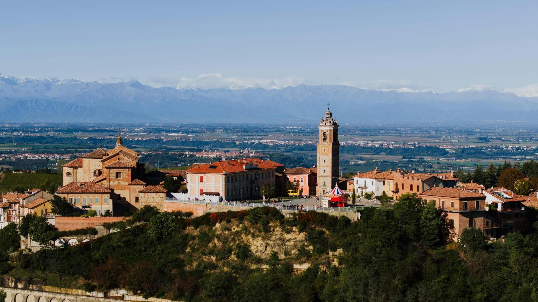 Explore the charming village of La Morra, Piemonte with its historic buildings and breathtaking mountain backdrop.