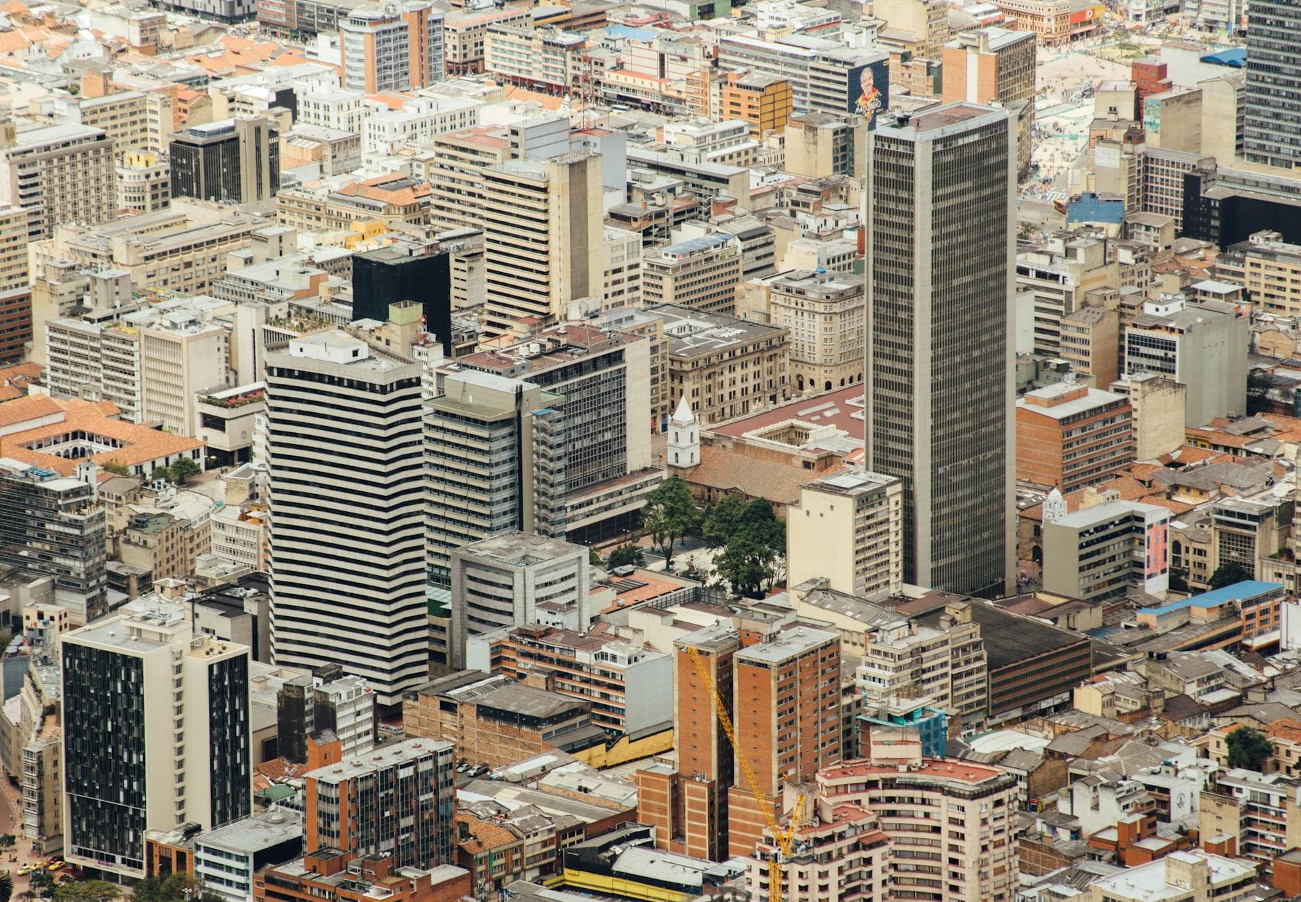 Aerial cityscape of downtown Bogotá featuring modern skyscrapers and urban architecture.