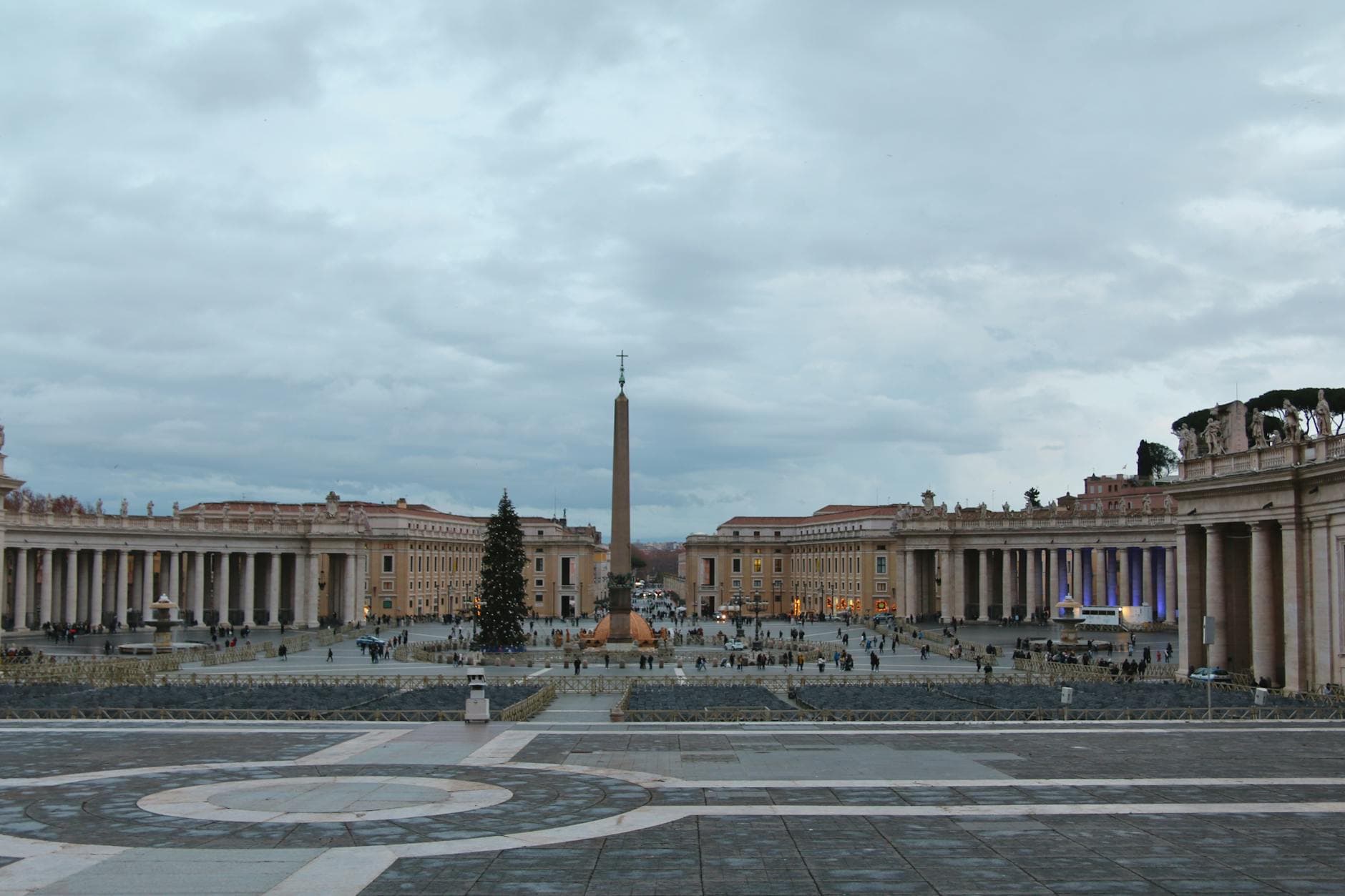 Wide view of St. Peter's Square in Vatican City with the iconic obelisk and surrounding architecture.