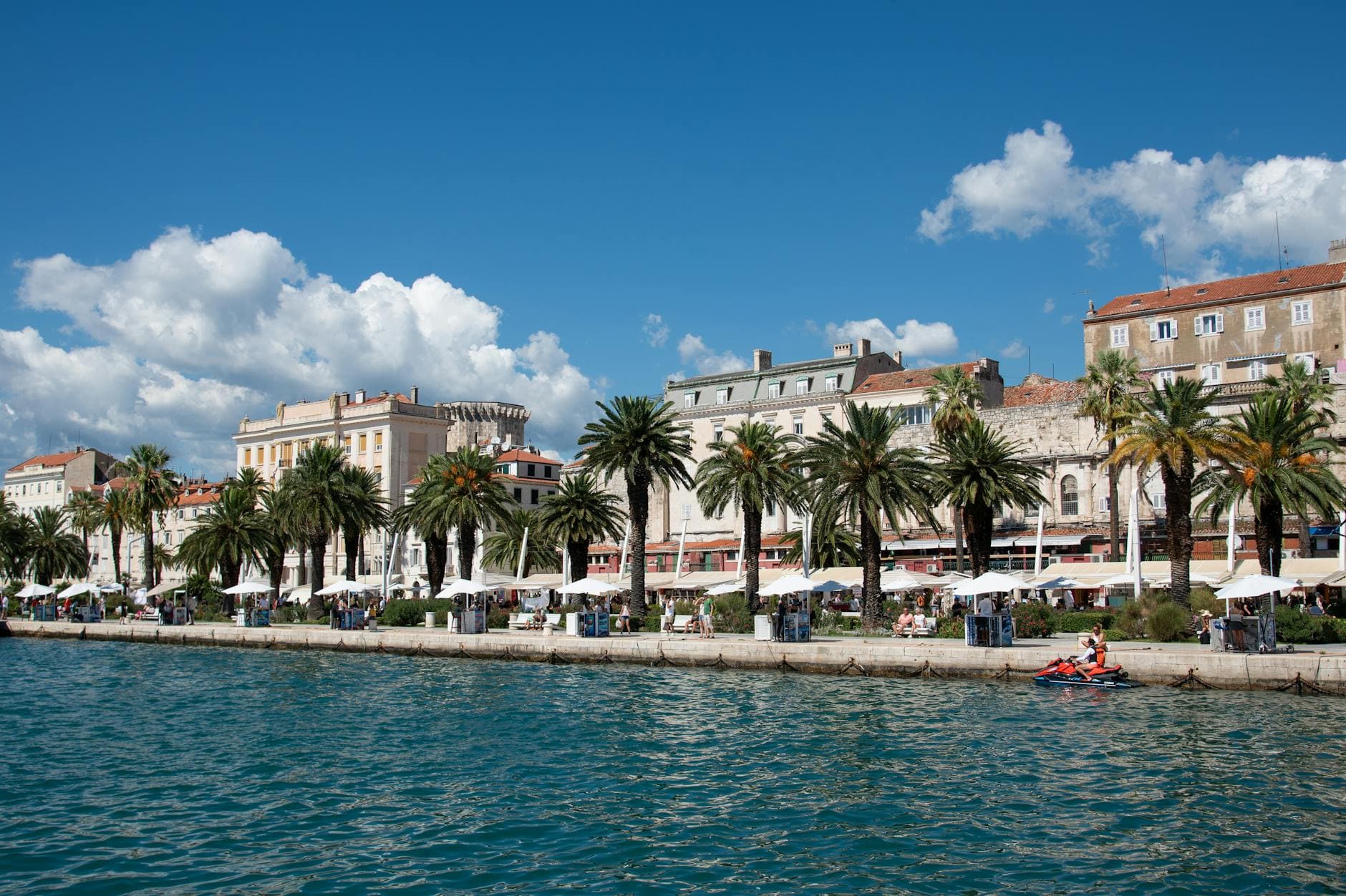 Captivating view of Split's waterfront promenade with palm trees and historic buildings.