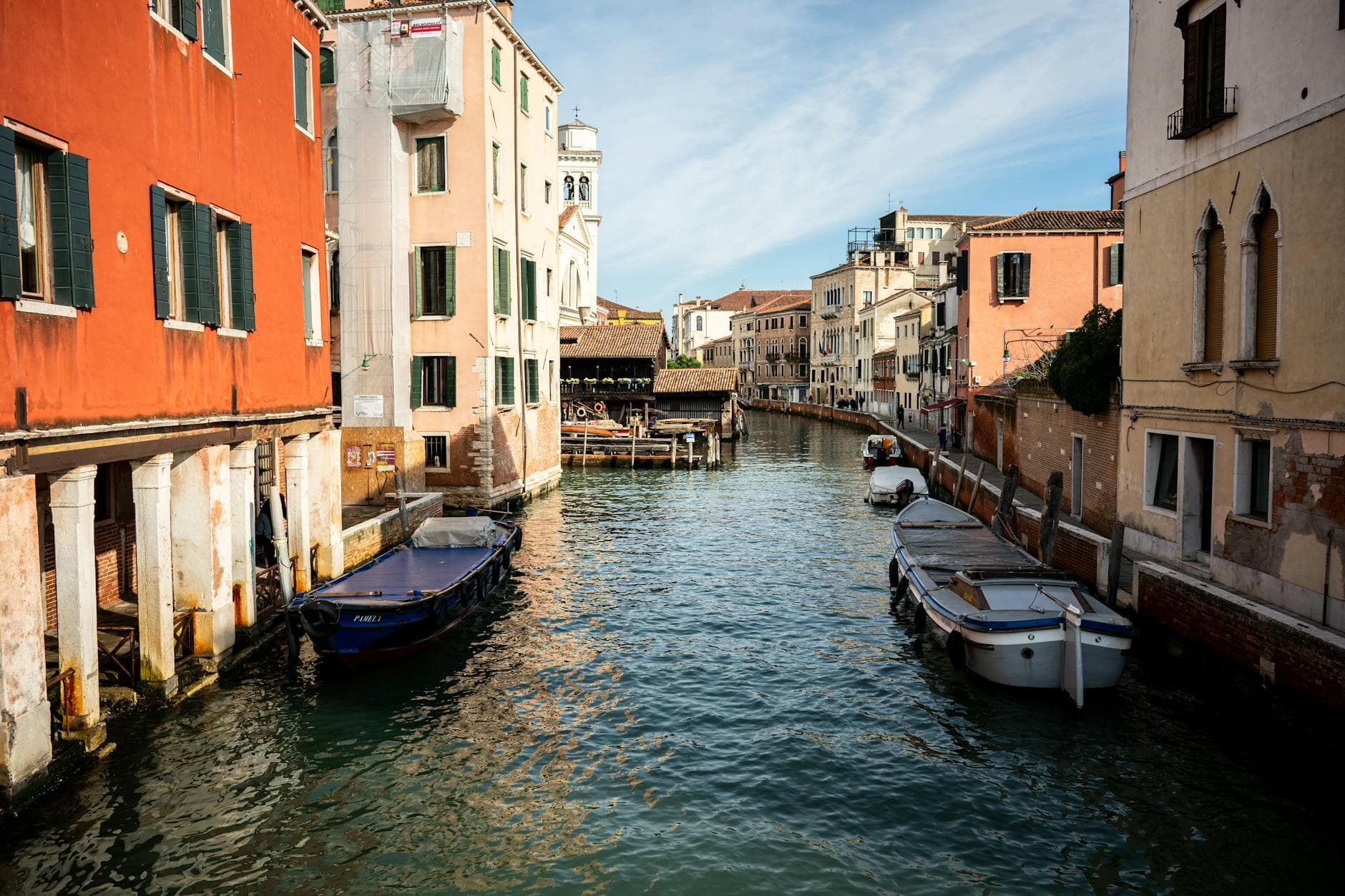 Charming view of a Venetian canal surrounded by colorful historic buildings in Venice, Italy.