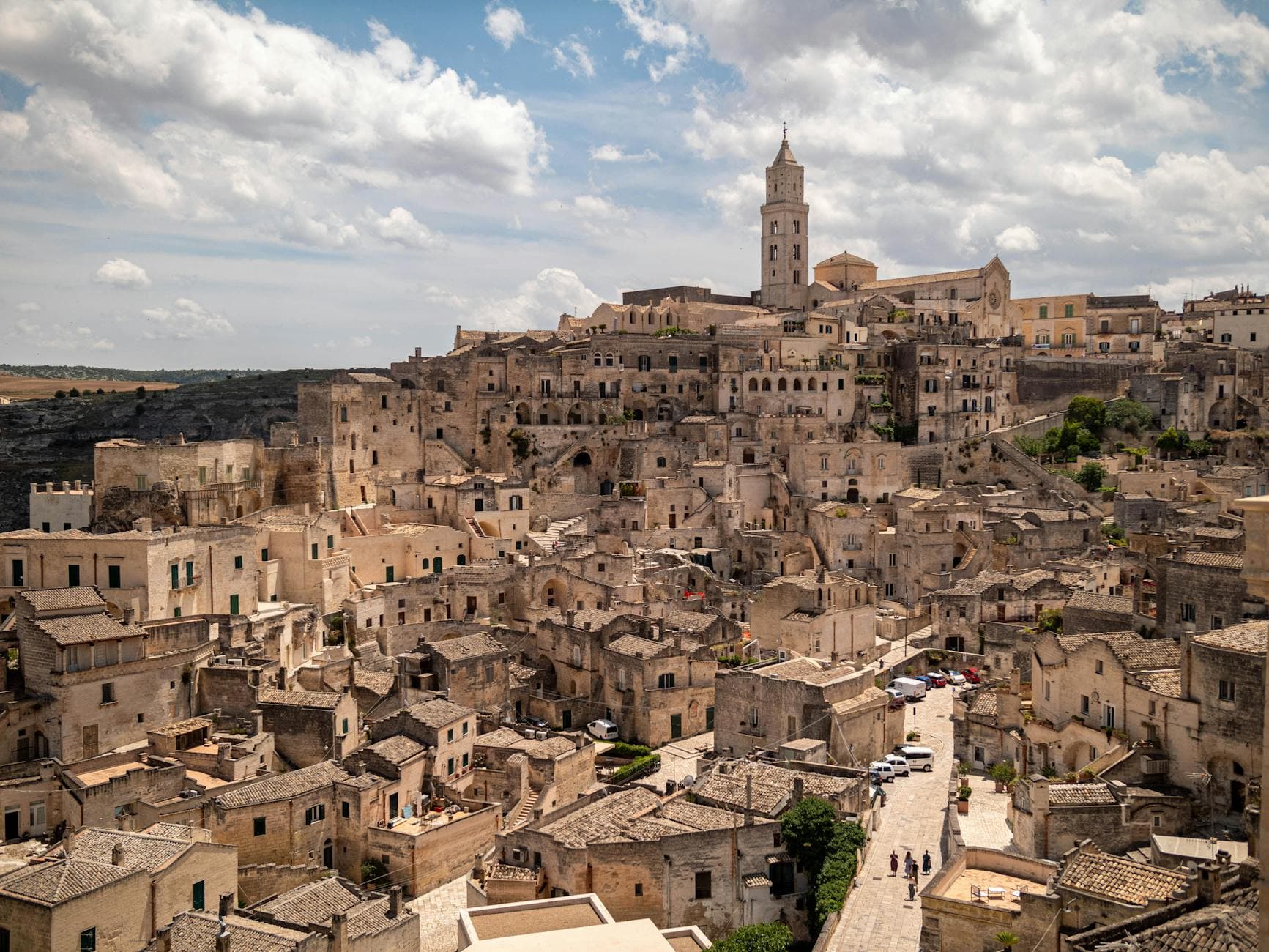Explore the ancient beauty of Matera, Italy, featuring stunning stone architecture under a vibrant sky.