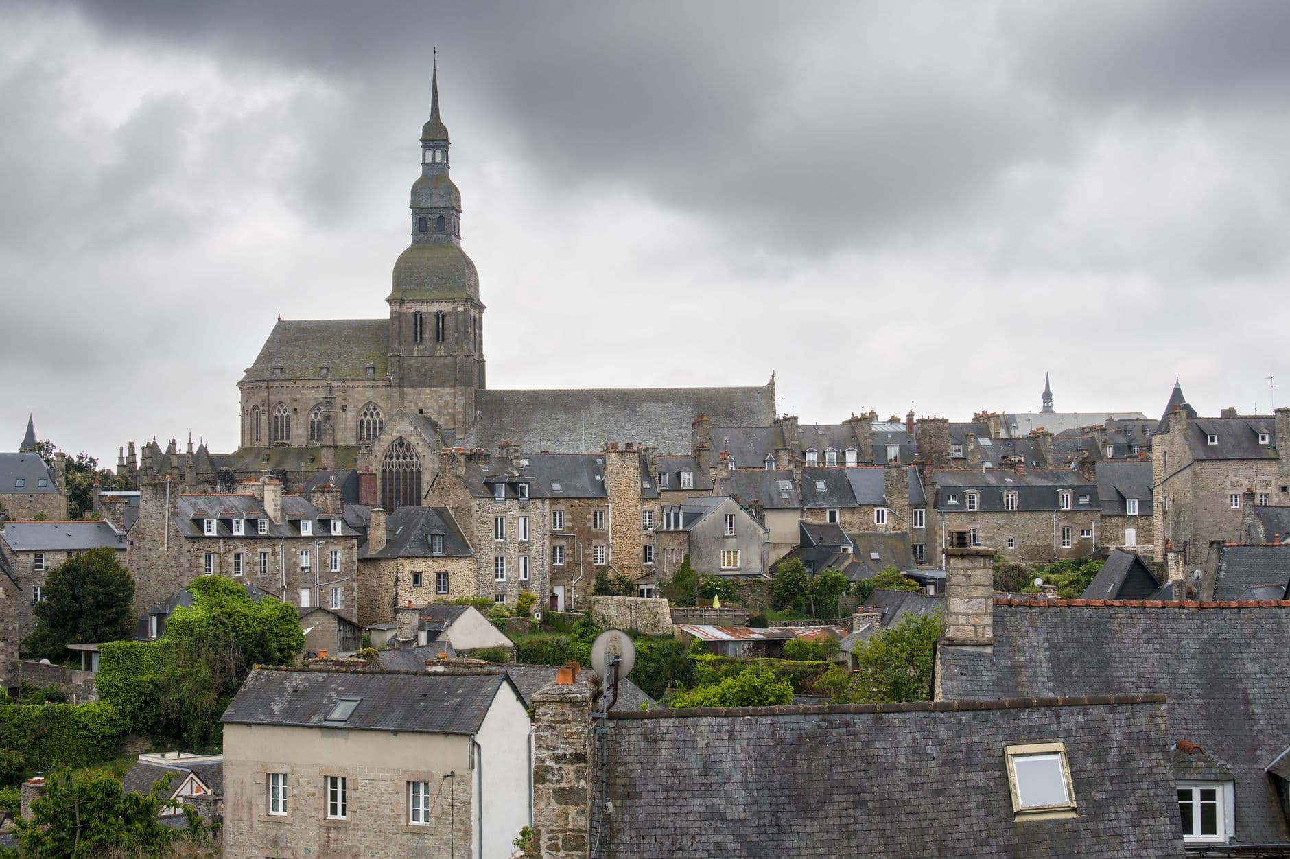 Aerial view of Saint-Brieuc's historic rooftops with the imposing cathedral in cloudy weather.