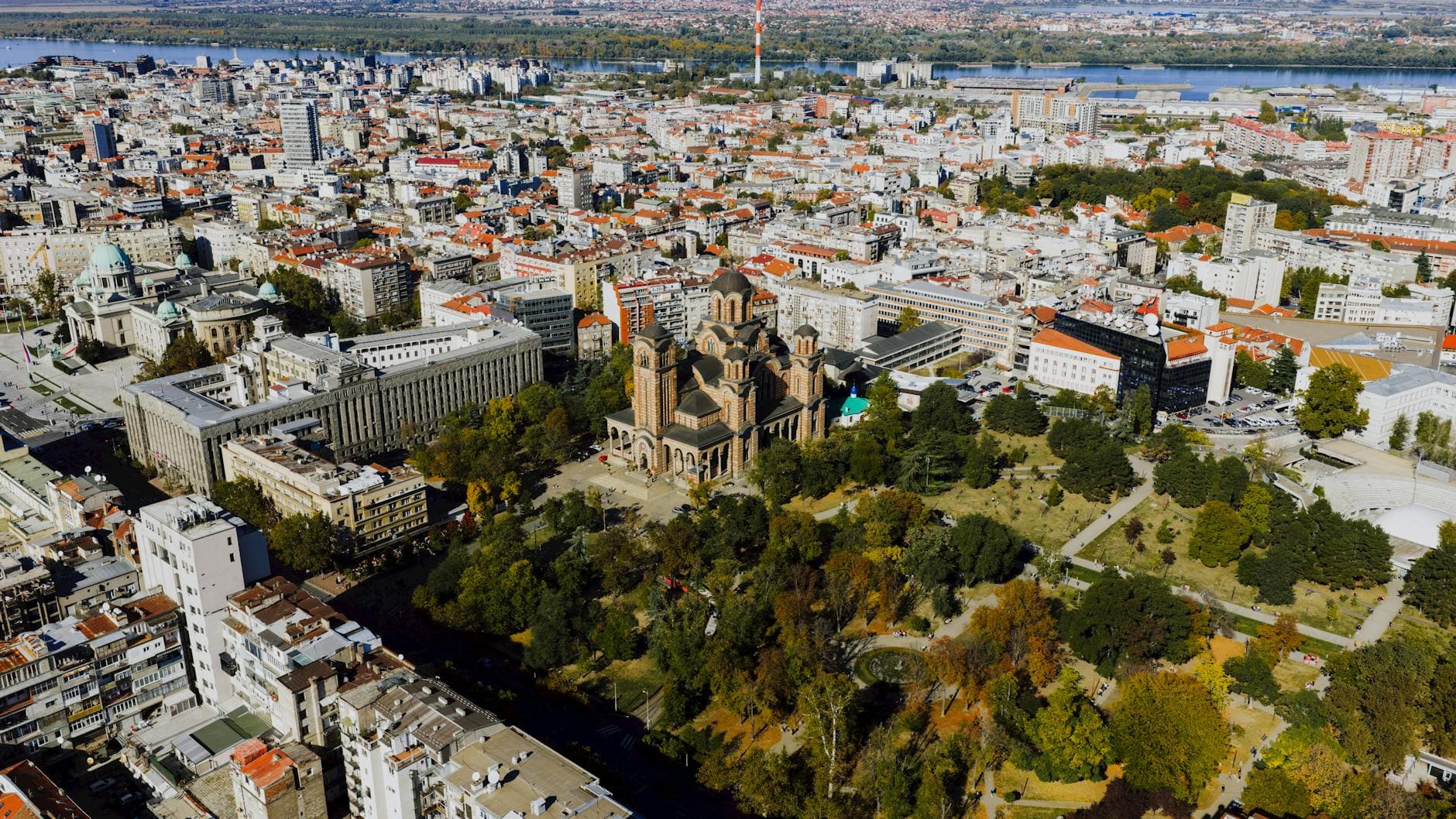 Aerial view of Belgrade skyline featuring St. Mark's Church amidst cityscape in autumn.