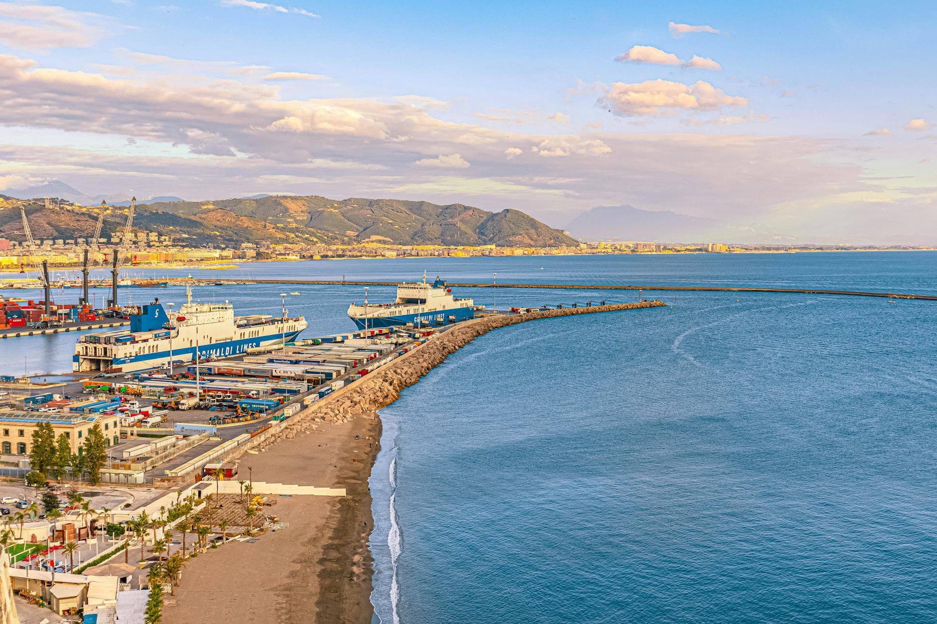 Aerial view of Vietri sul Mare harbor with ships and coastal landscape in Italy.