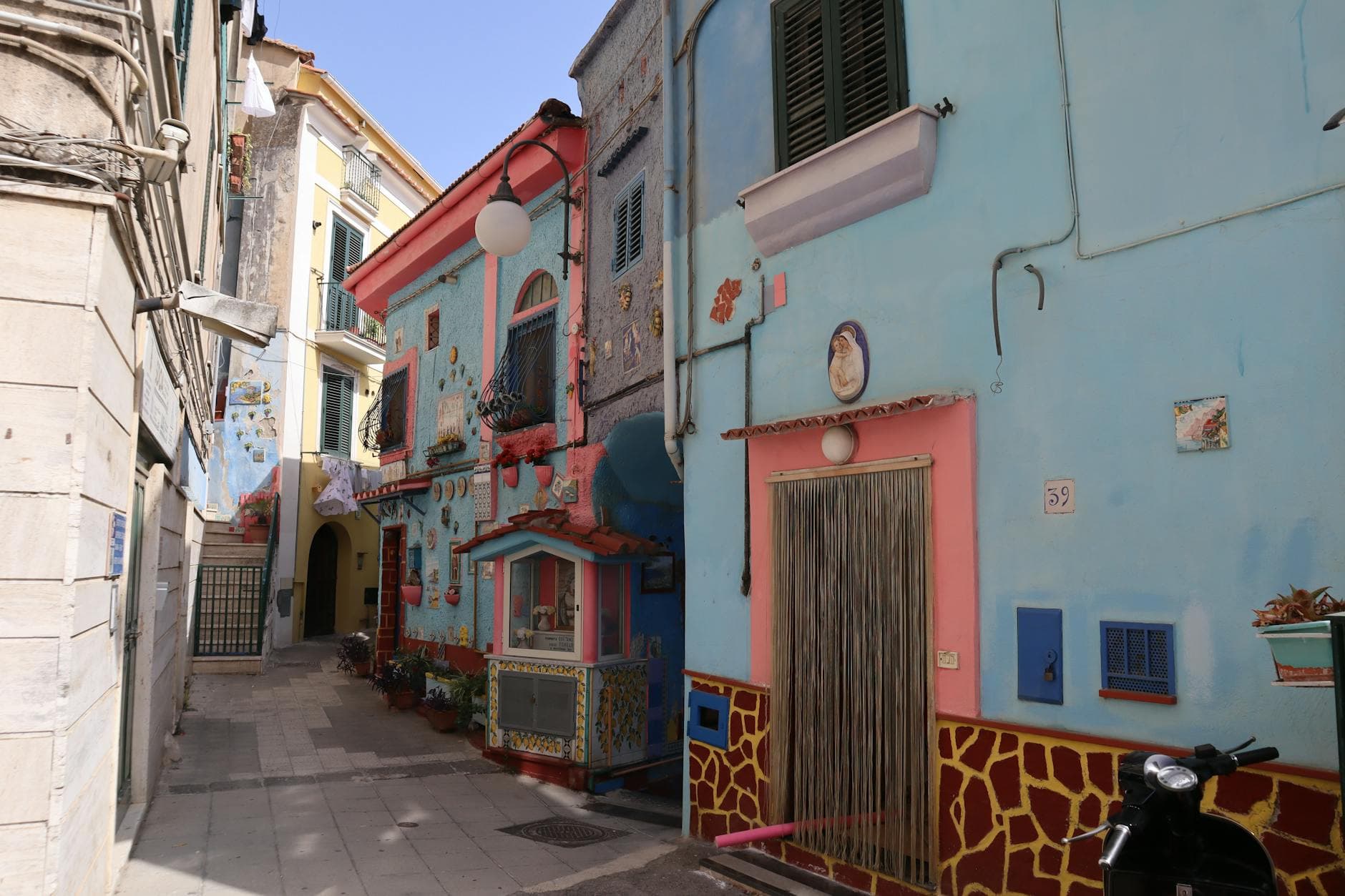Vibrant street view in Vietri sul Mare, Italy, featuring colorful houses and artistic facades.