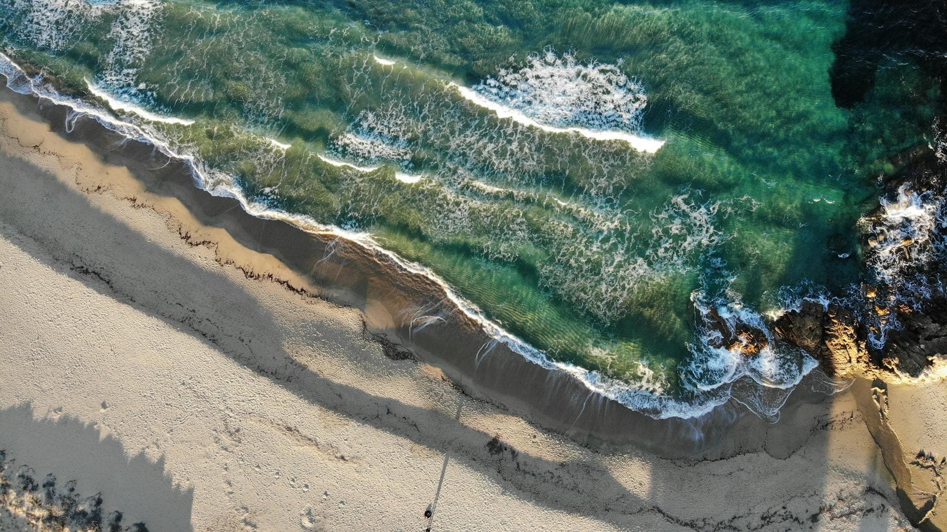 Aerial view of stunning crashing waves on Castiadas Beach, Sardinia, Italy.