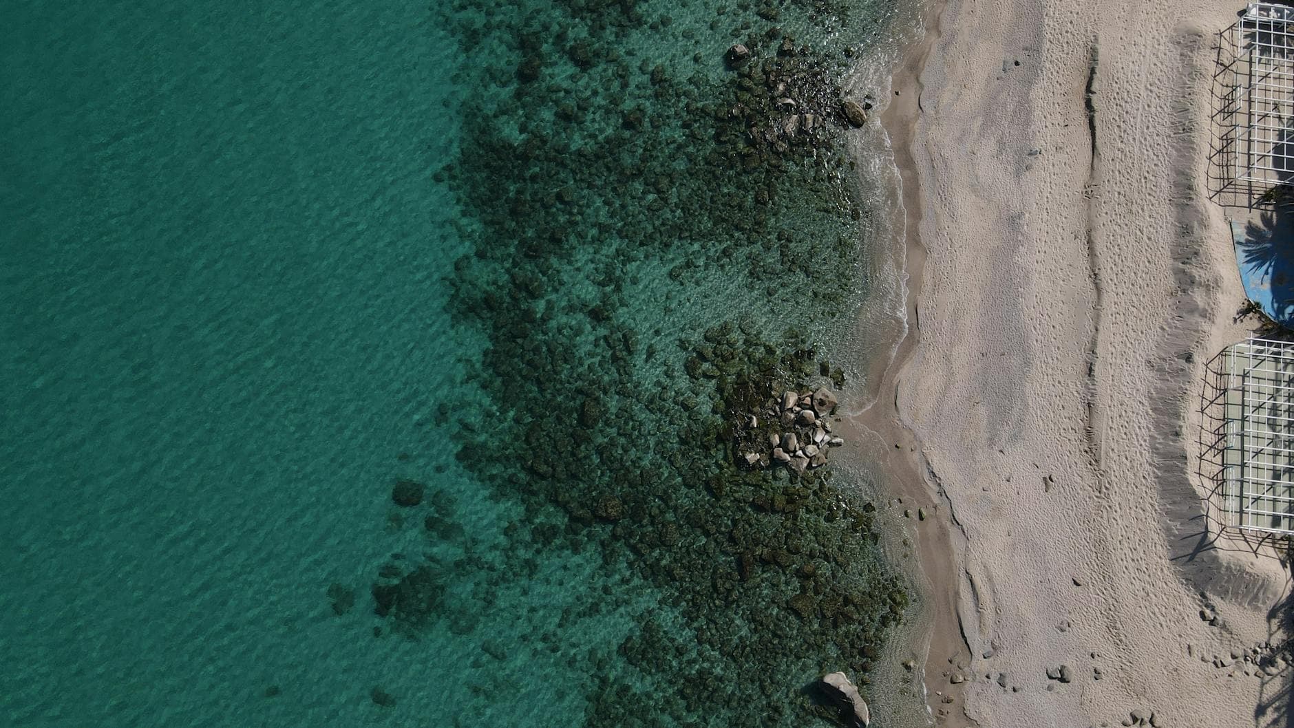 Stunning aerial shot of Soverato beach in Italy, showcasing turquoise waters and sandy shore.