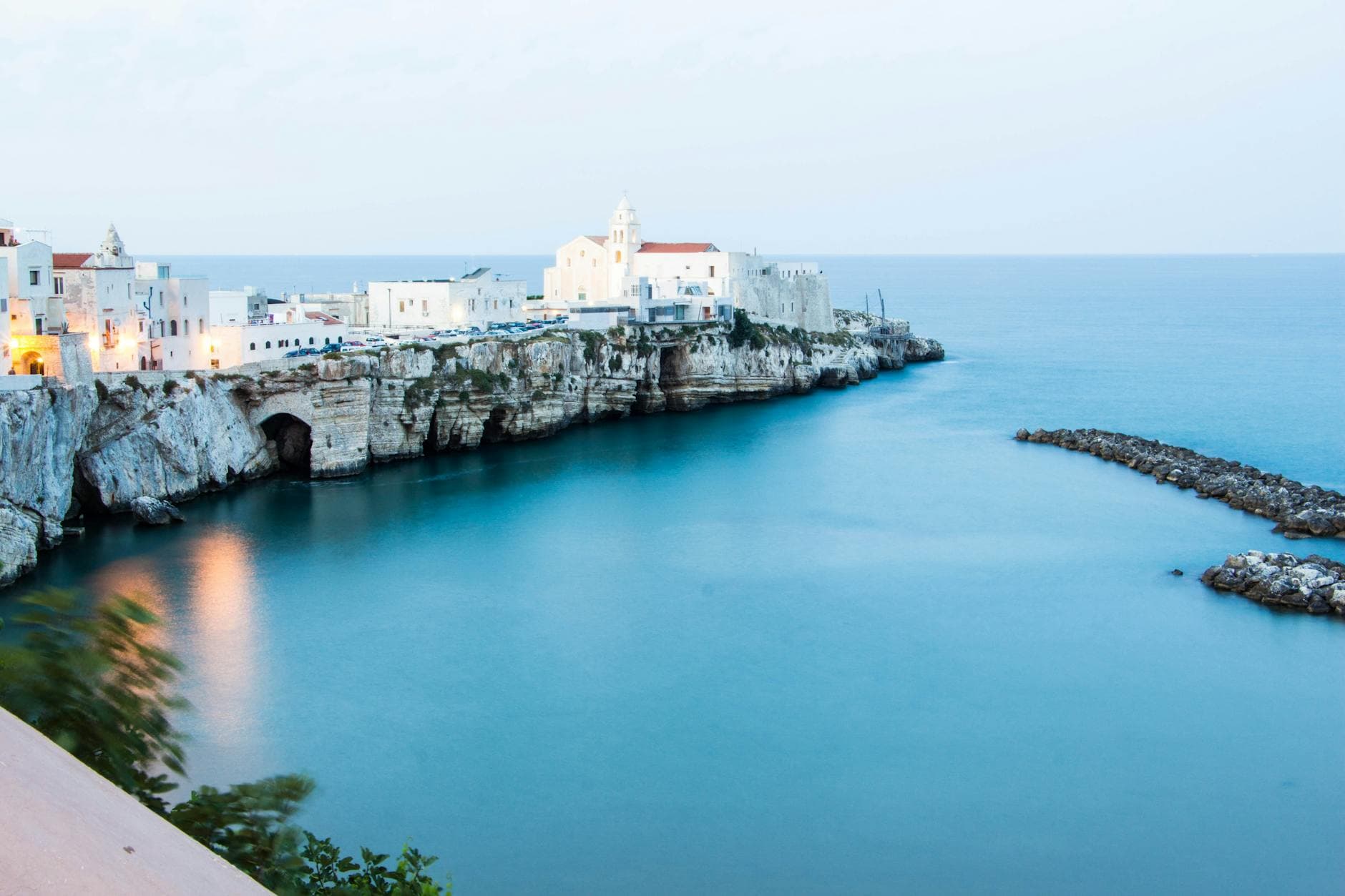 Beautiful seaside town of Vieste, Italy with a cliffside view and clear blue waters.
