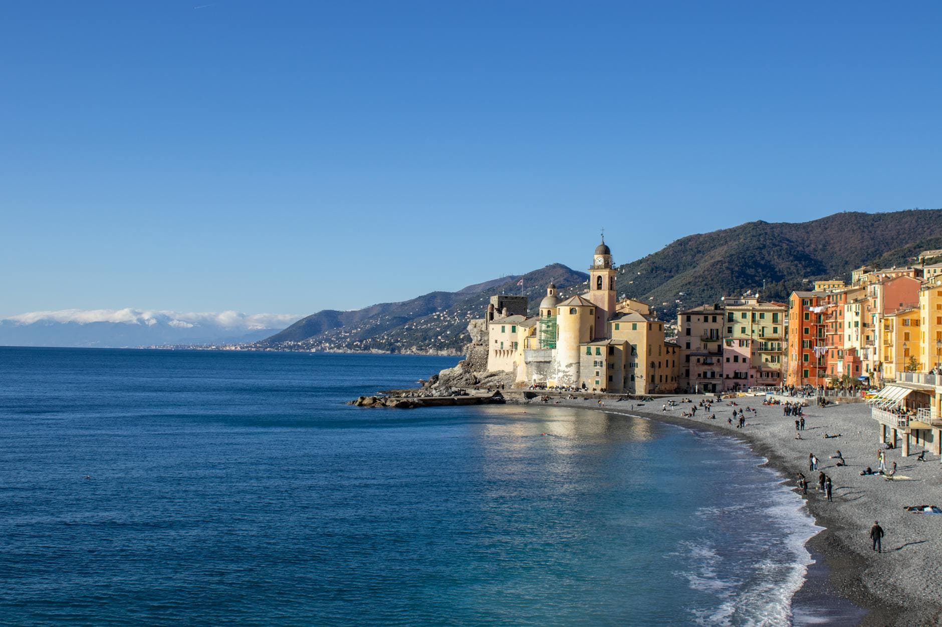 Picturesque view of Camogli's colorful buildings along the beach in Liguria, Italy.