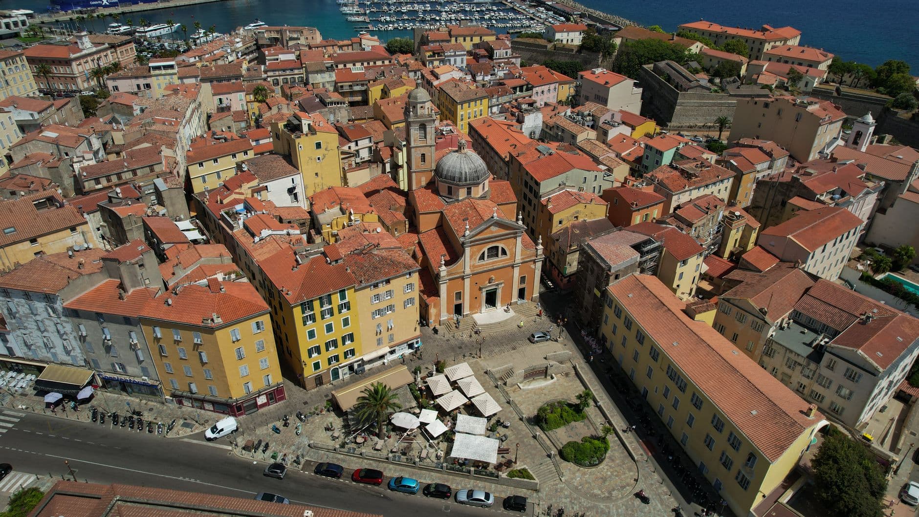 Stunning aerial view of Ajaccio showcasing historic architecture with vibrant rooftops by the coast.