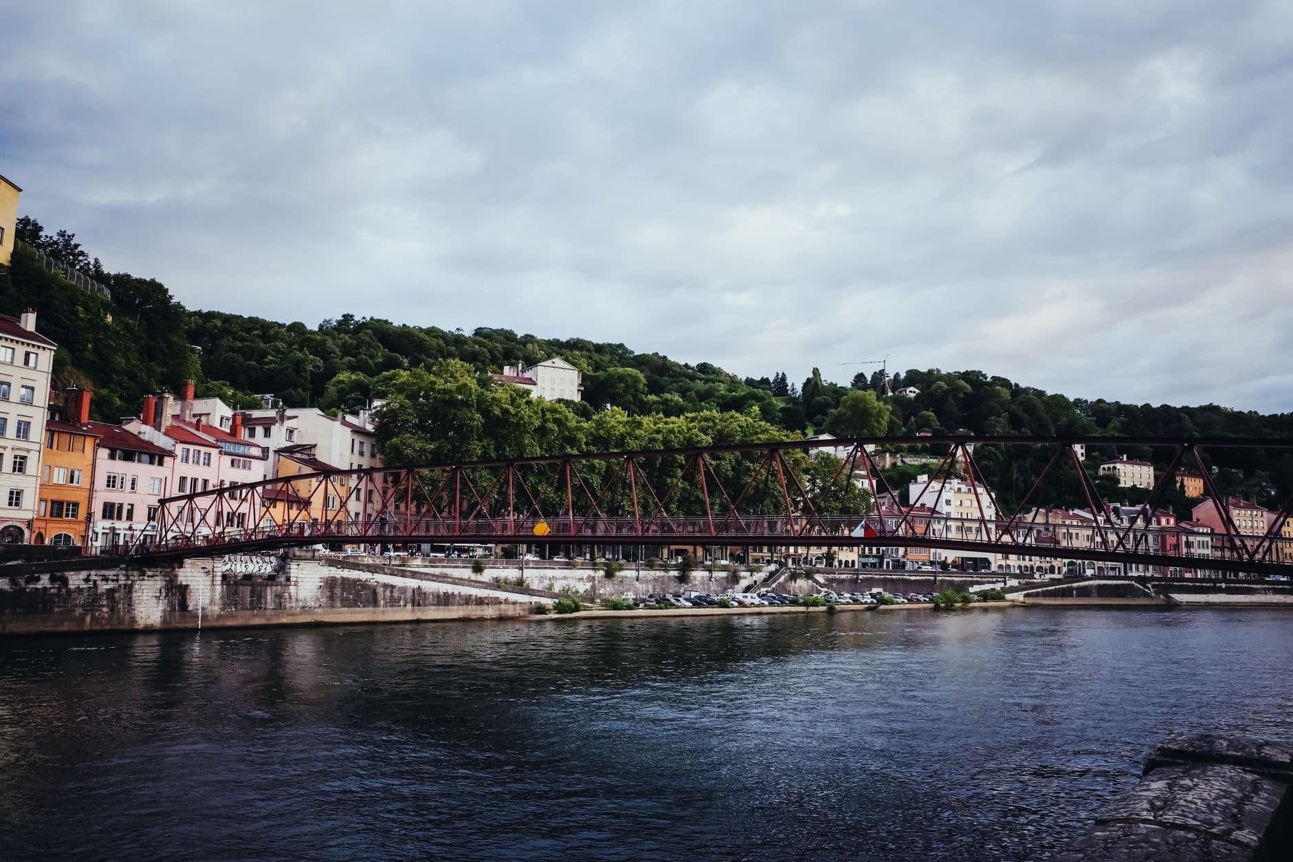 Picturesque view of a historic footbridge over the Saône River in Lyon, France.