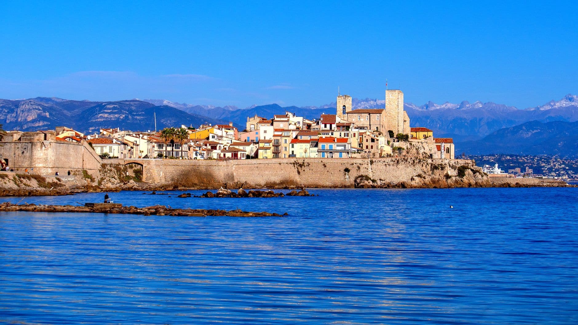 Explore the picturesque view of Antibes with vibrant buildings by the sea in Provence, France.