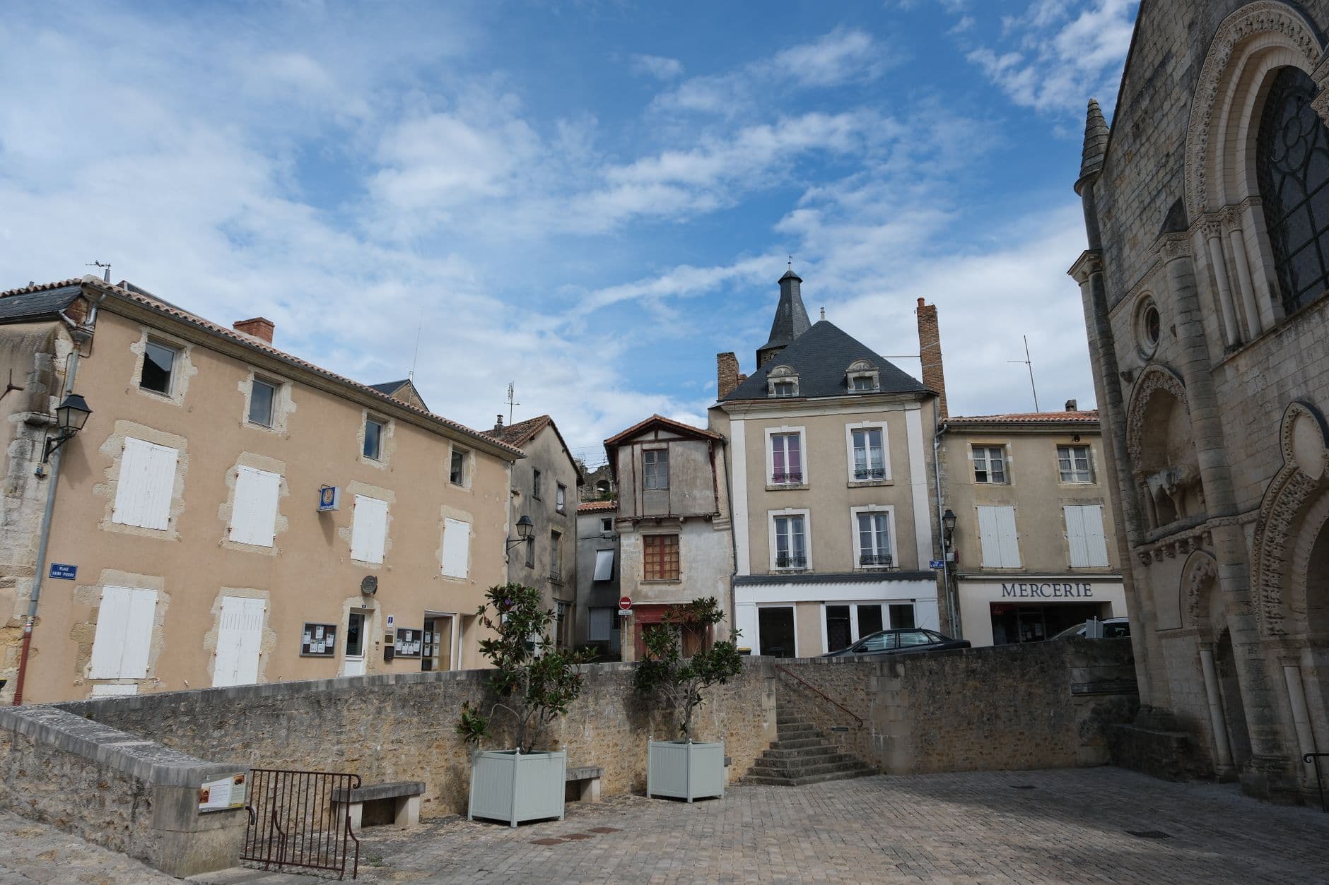 Picturesque view of a historic European town square with old buildings and an overcast sky.