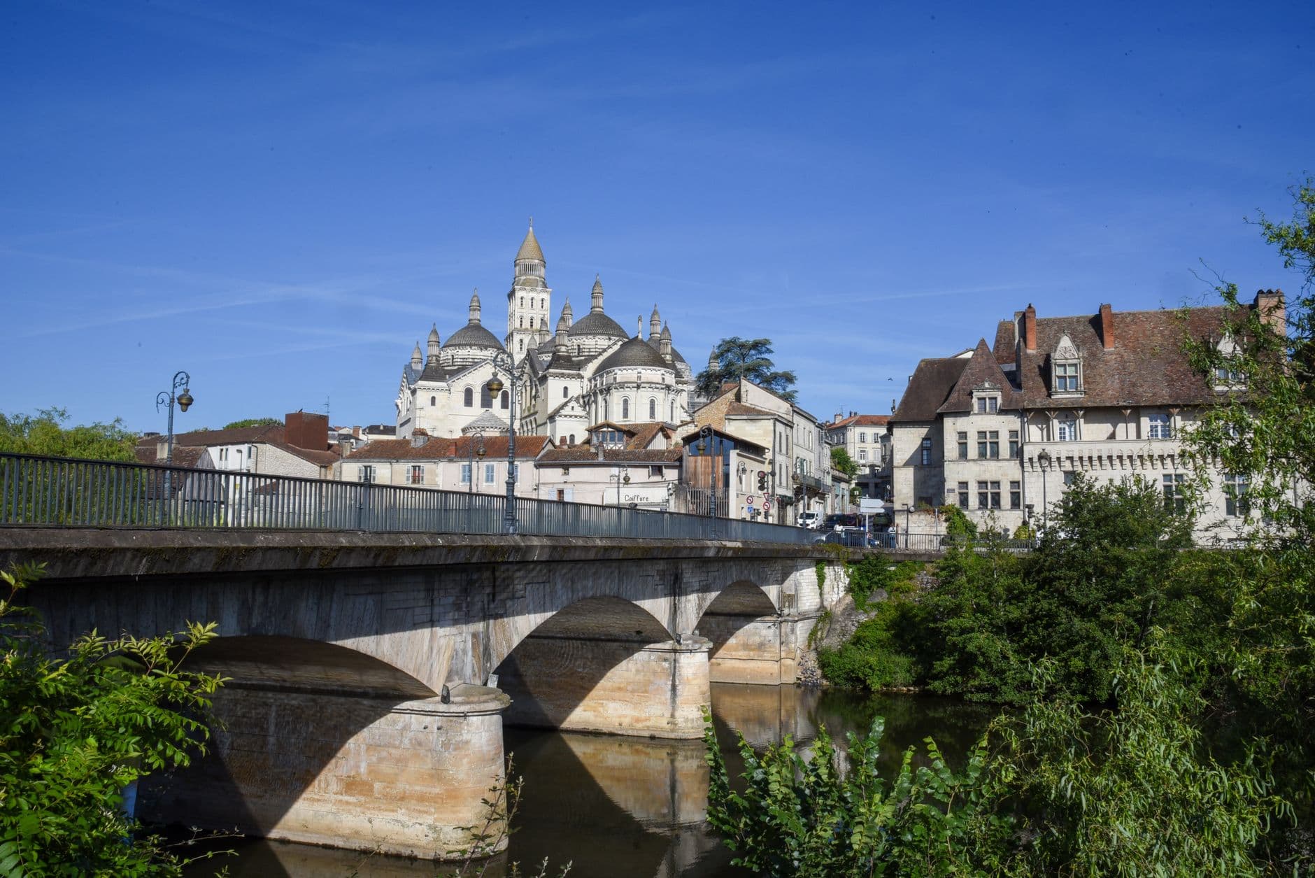 Beautiful summer view of Périgueux Cathedral and historic bridge in Périgueux, France.