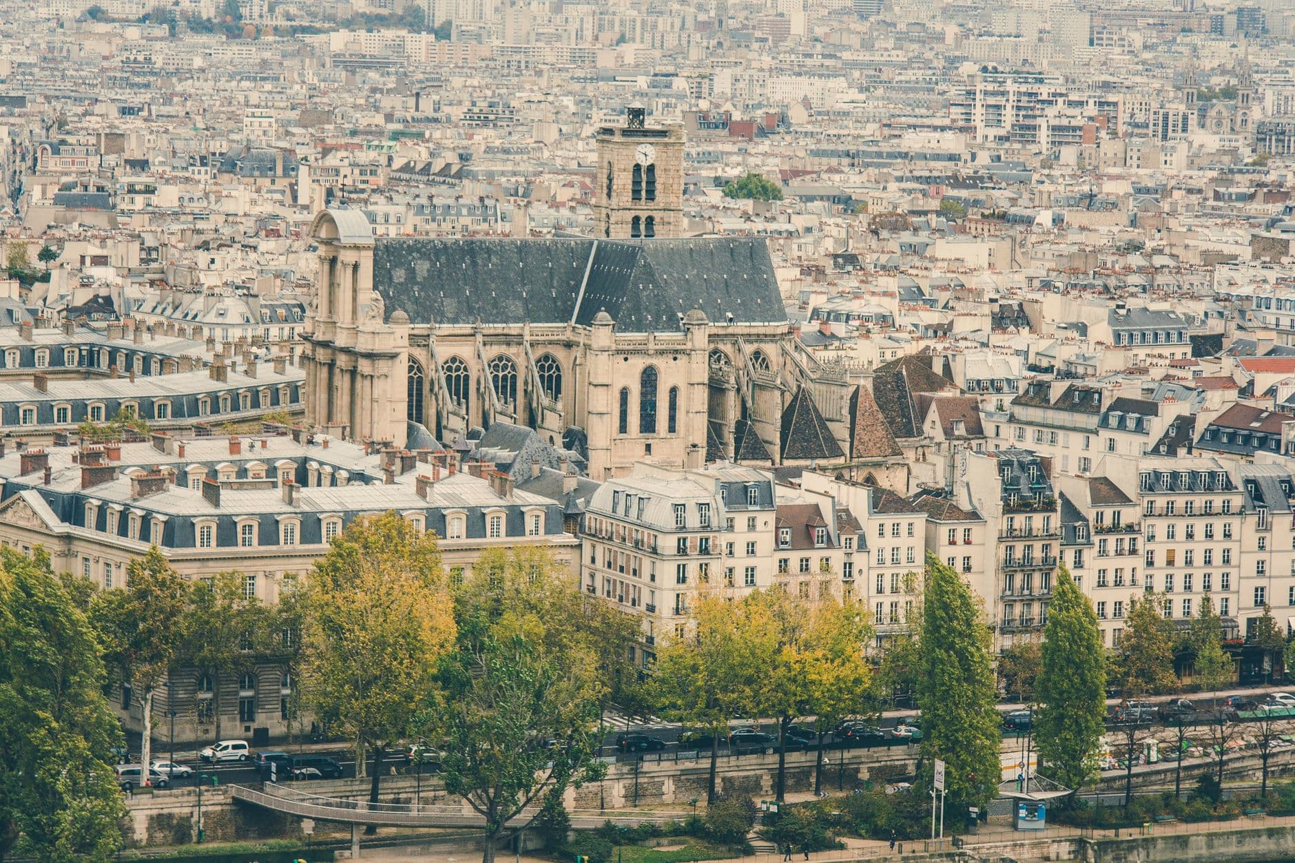 Aerial shot of a historic cathedral amidst the urban landscape of Paris, France.