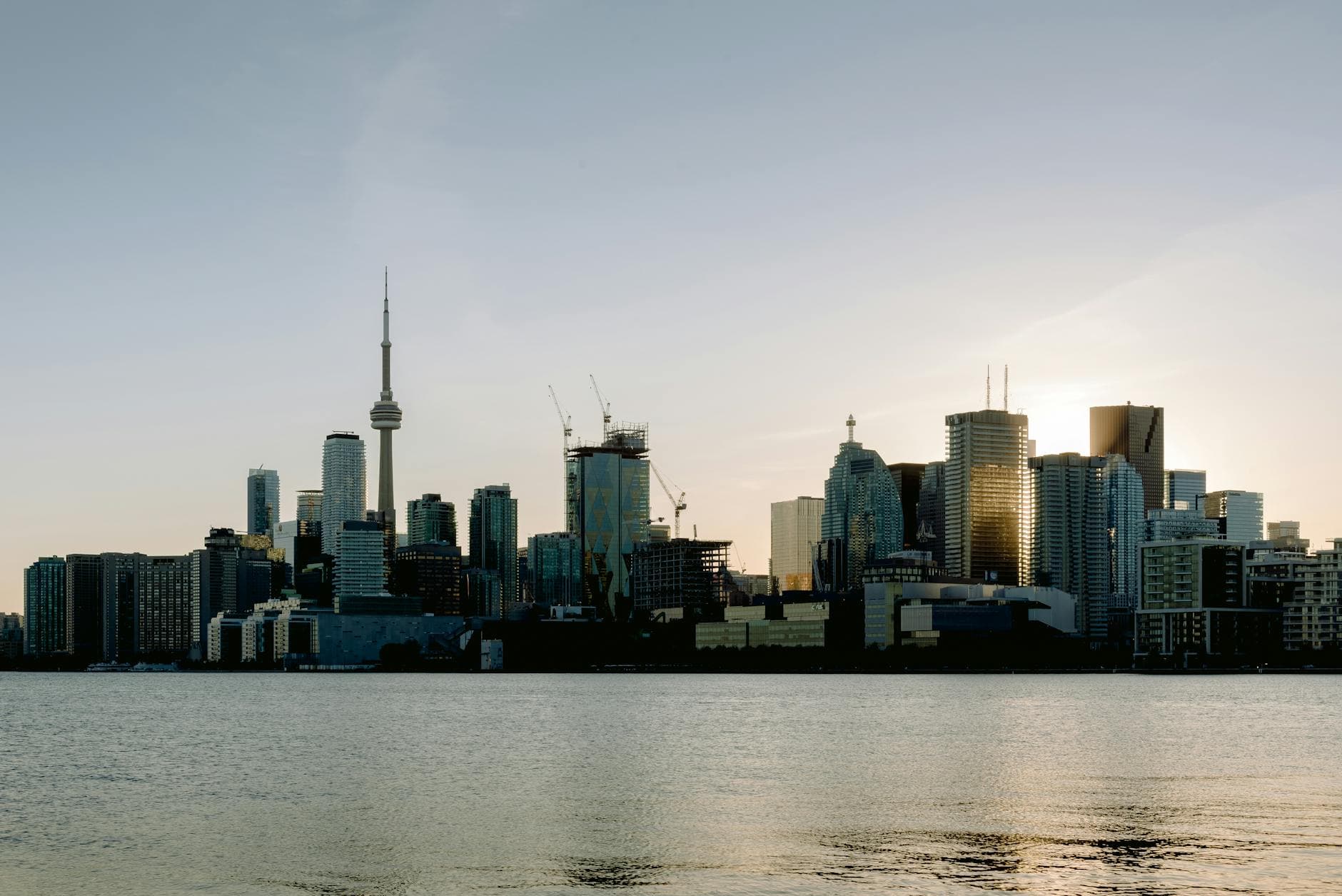 Beautiful view of Toronto's skyline featuring the CN Tower at sunset across the waterfront.
