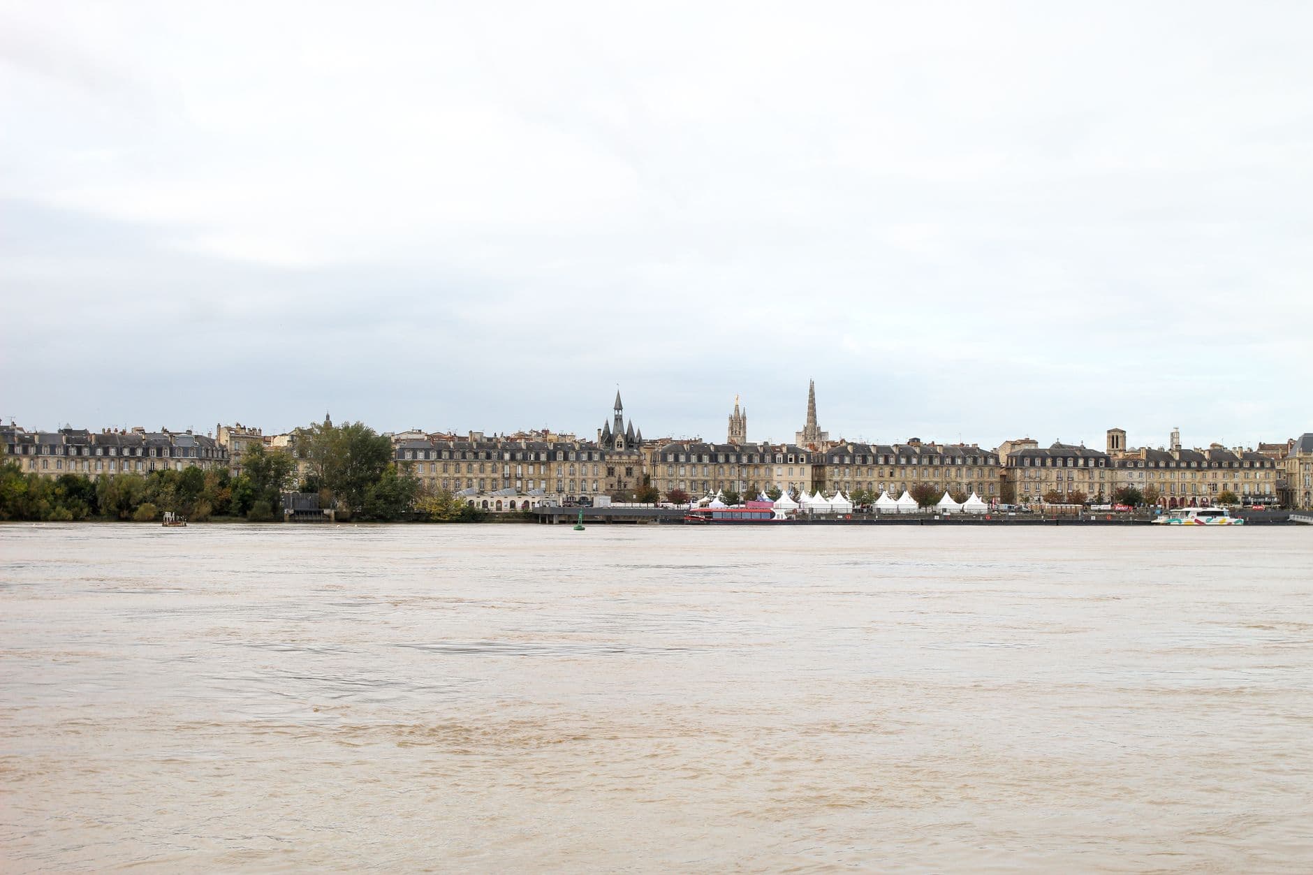 A scenic view of Bordeaux, France with historical architecture along the riverbank.
