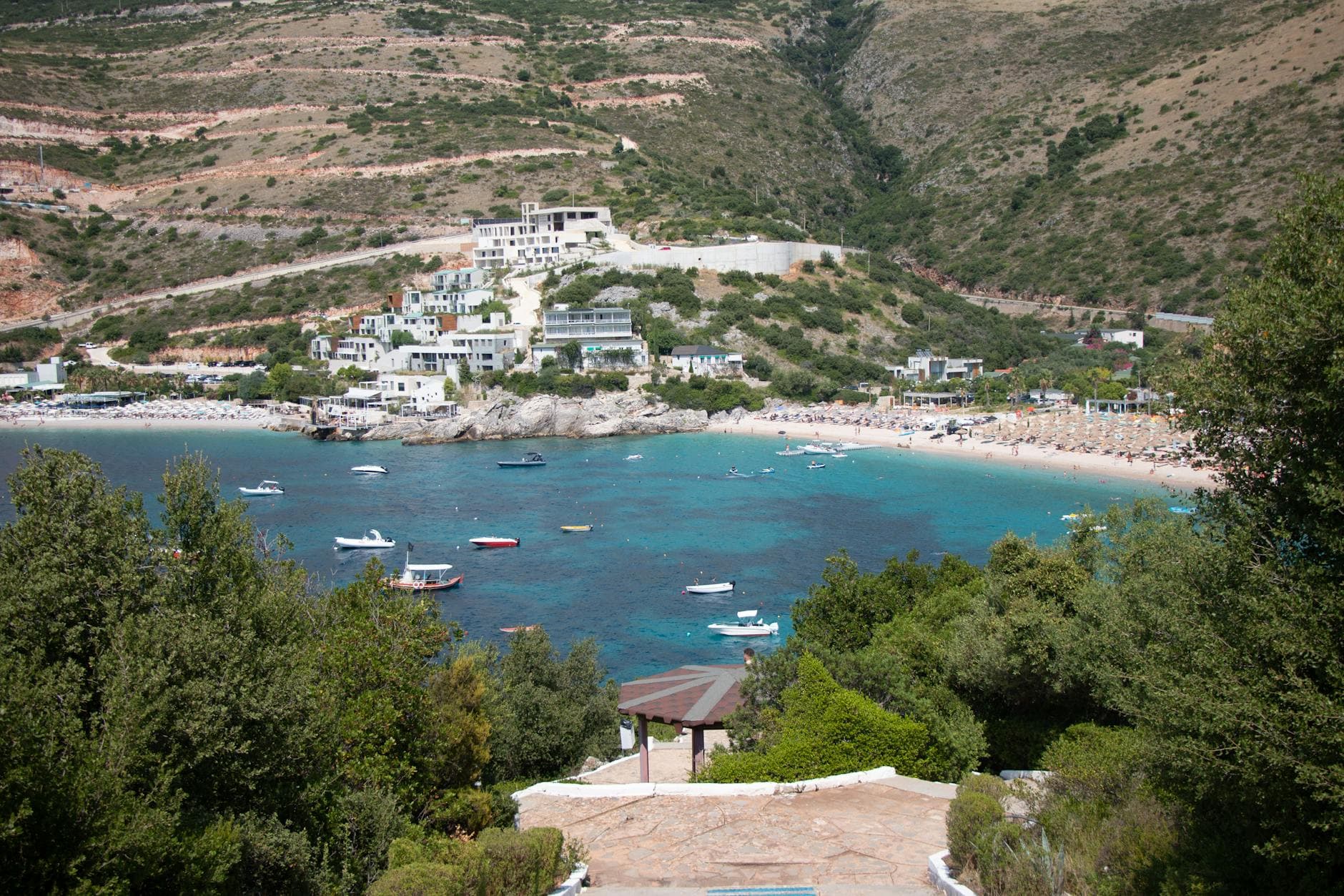A picturesque view of Jale Beach with boats in Vlorë County, Albania, perfect for summer vacations.