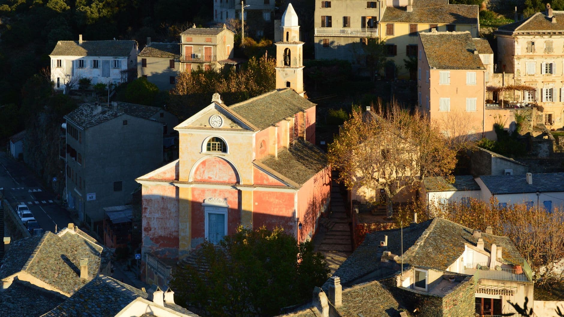 Charming aerial view of the historic church and village in Nonza, Corsica, France.