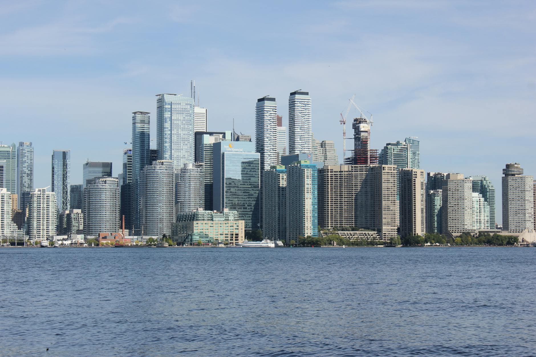 Scenic view of Toronto's modern skyline and waterfront from Lake Ontario.