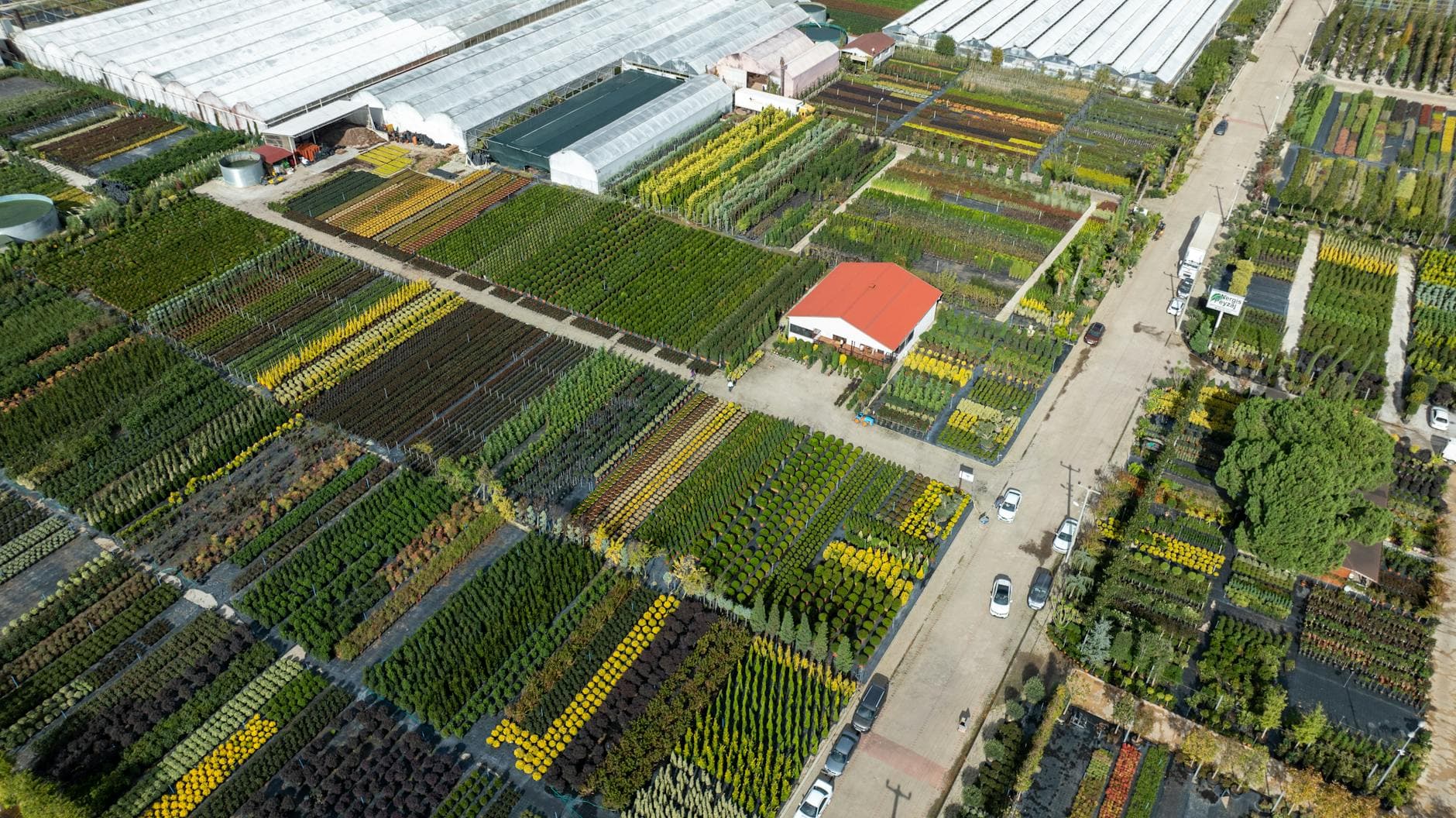 Aerial shot of greenhouses and nurseries, showcasing vibrant agriculture in Yalova, Turkey.