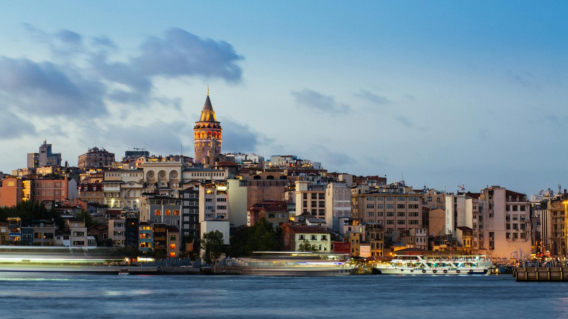 Beautiful evening cityscape of Istanbul with the iconic Galata Tower and waterfront.