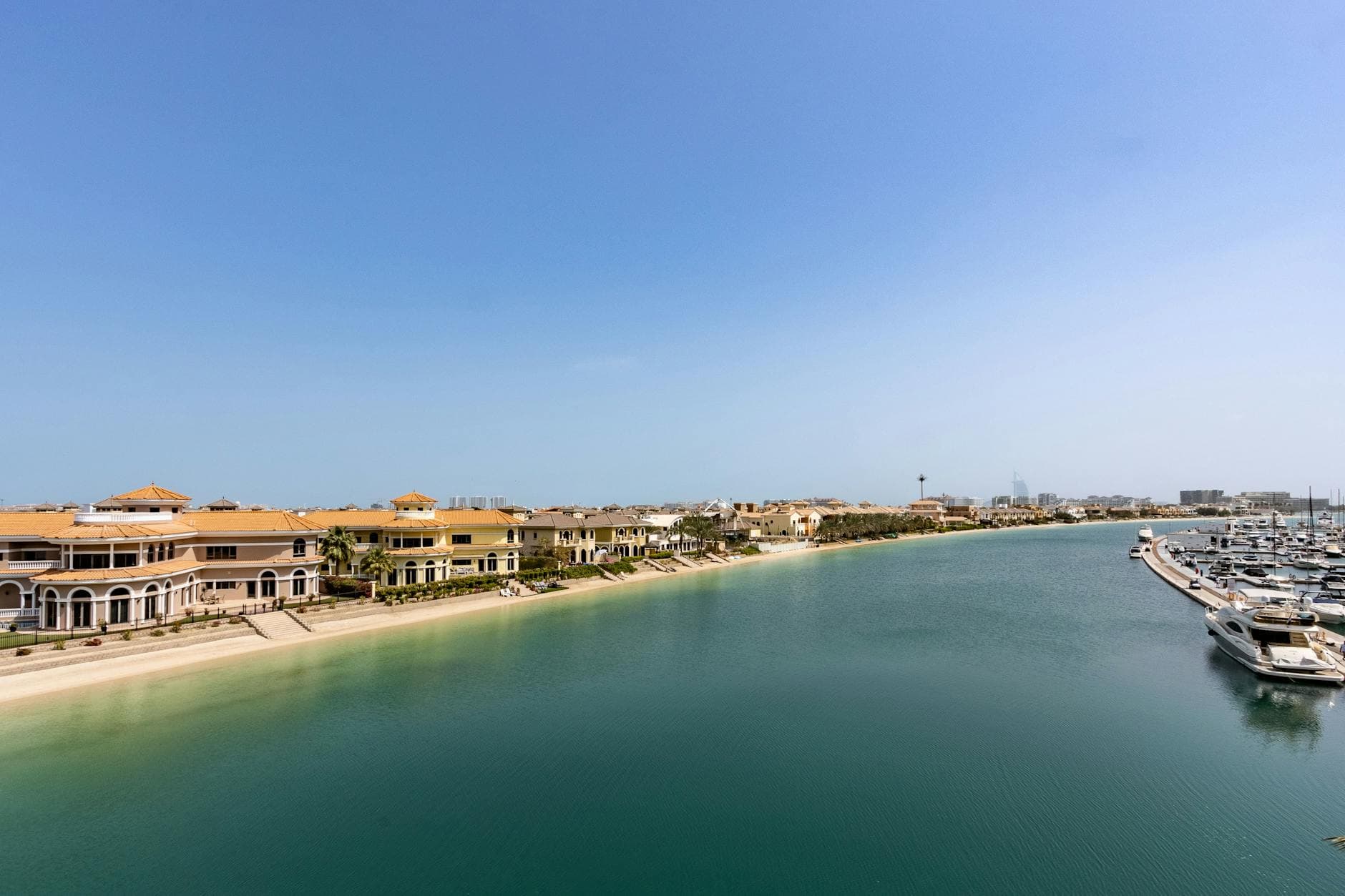 Scenic aerial view of luxurious villas and yachts on Palm Jumeirah in Dubai, UAE.